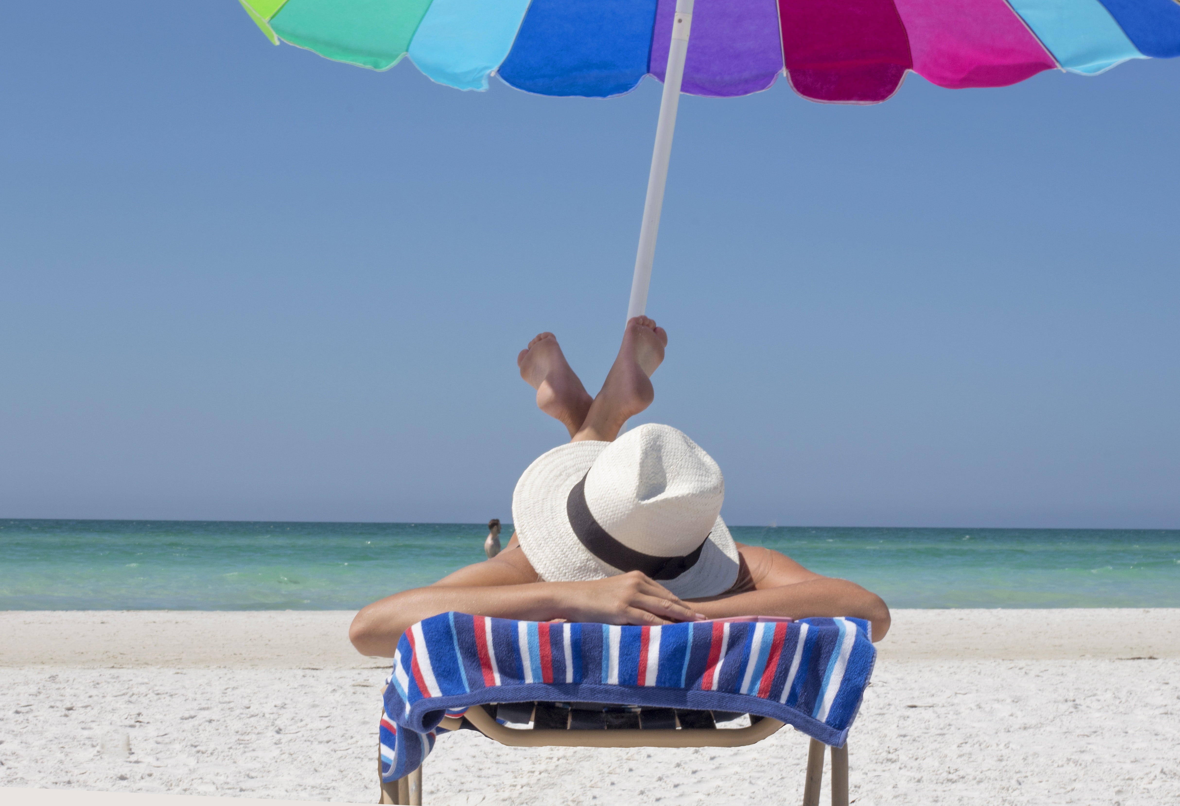 person lying down on beach chair vacation relax travel sun 2k 4k 5k