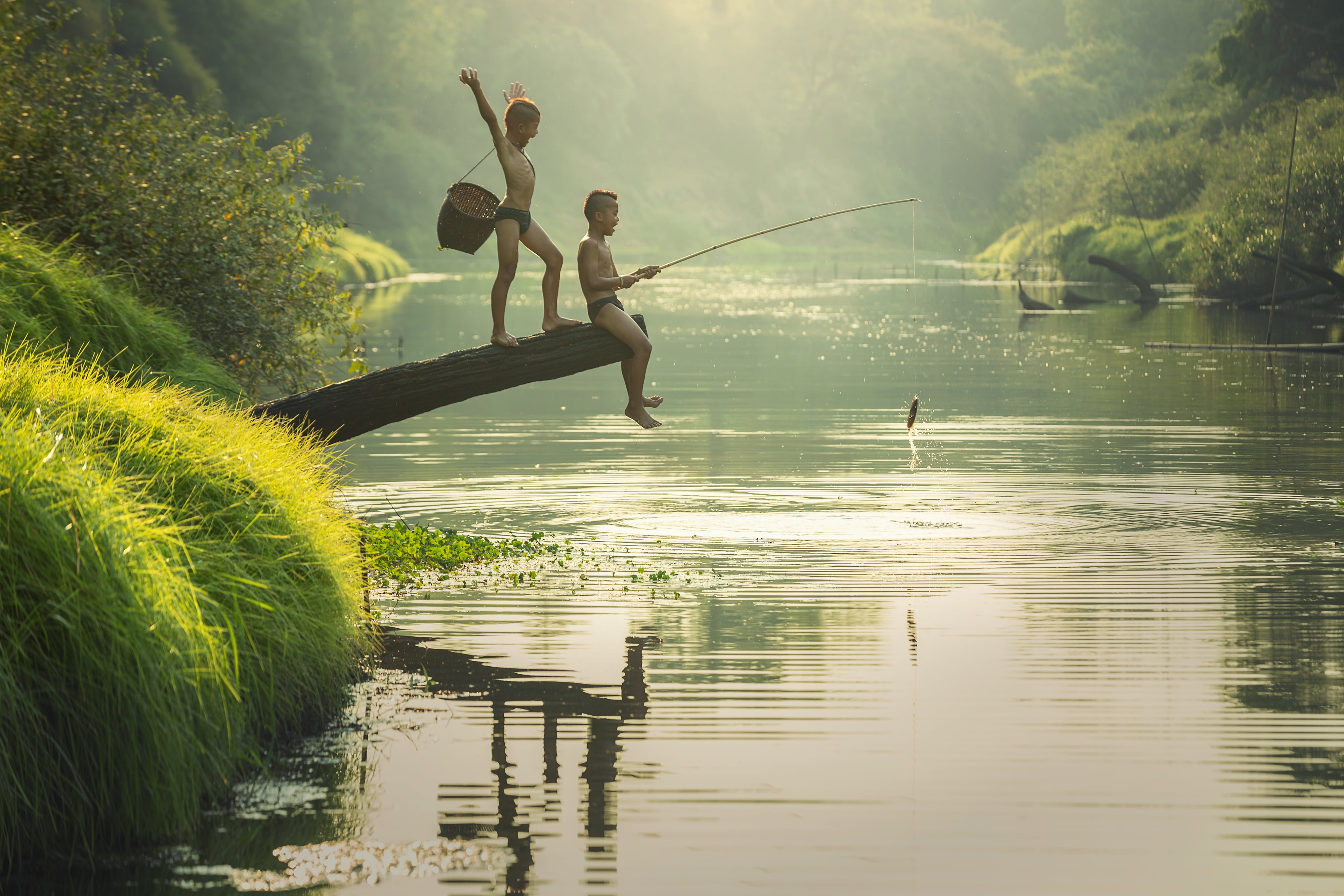 two boys fishing in a river talented people the activity asia 2k 4k