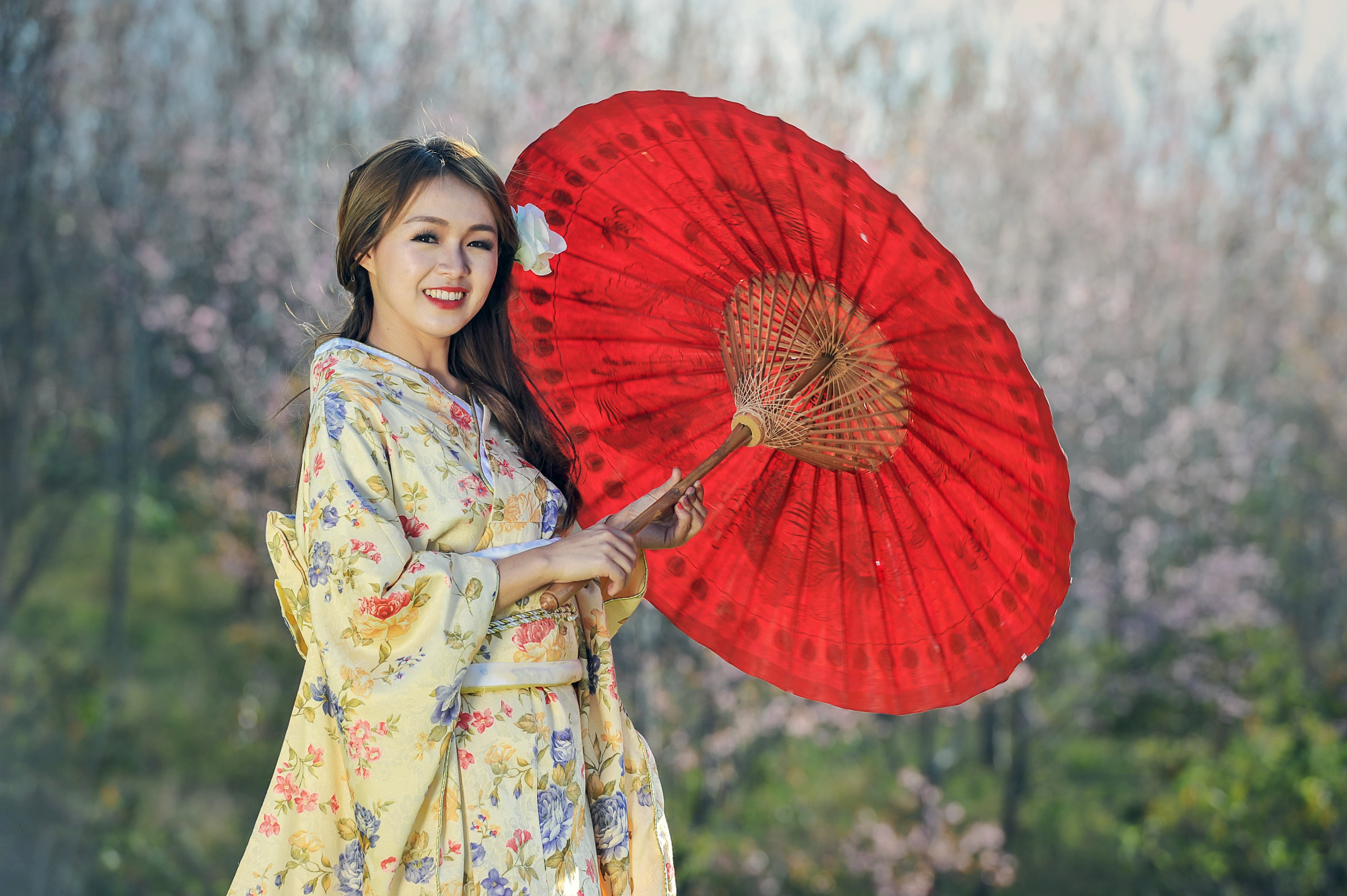 woman in beige floral dress holding oil paper umbrella beauty 2k 4k
