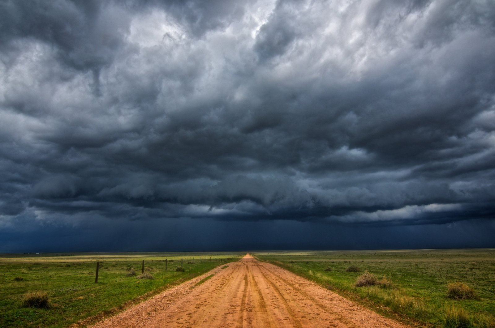 brown dirt road under black clouds landscape nature field 2k 4k