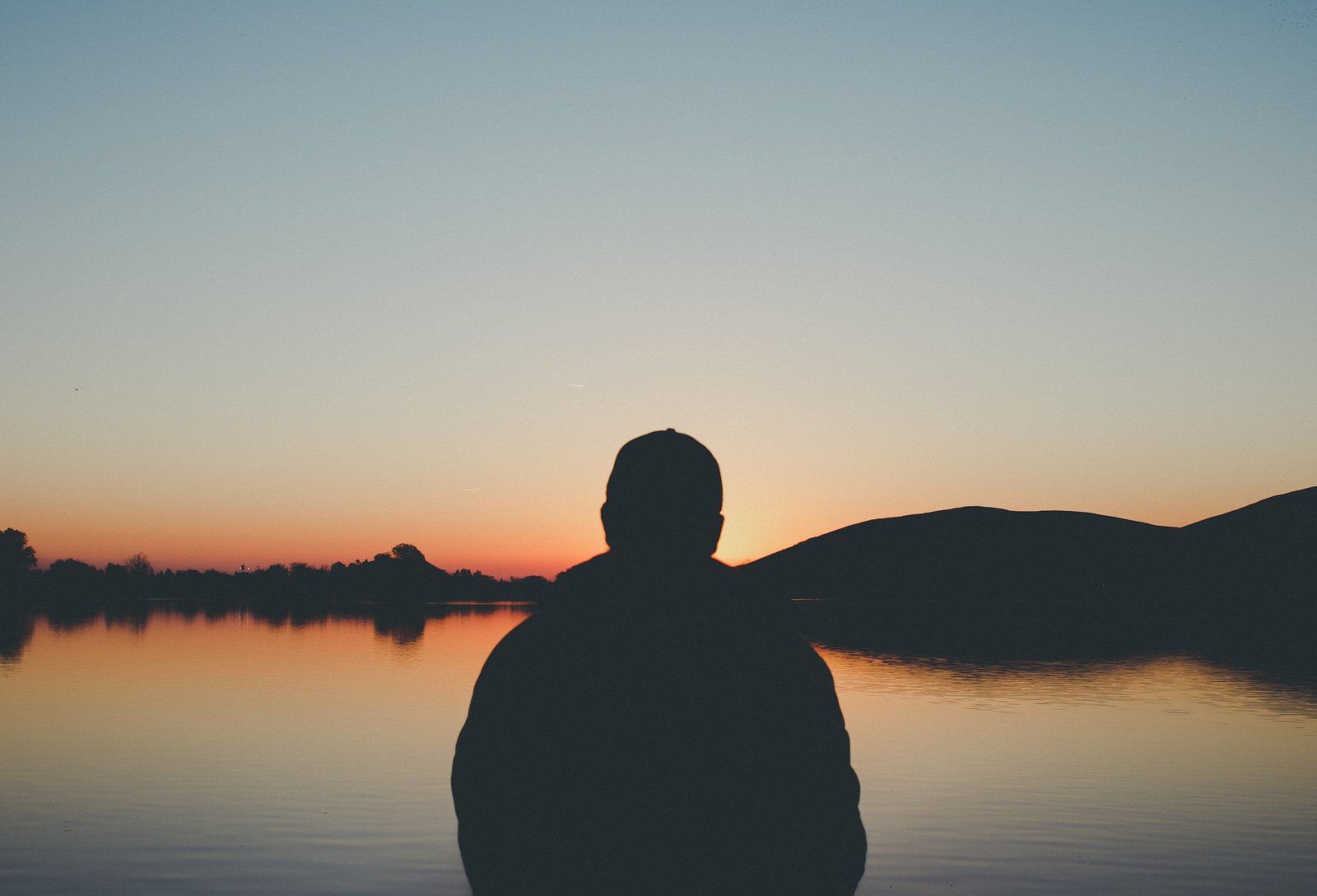 silhouette of man in front beach during golden hour person 2k 4k 5k
