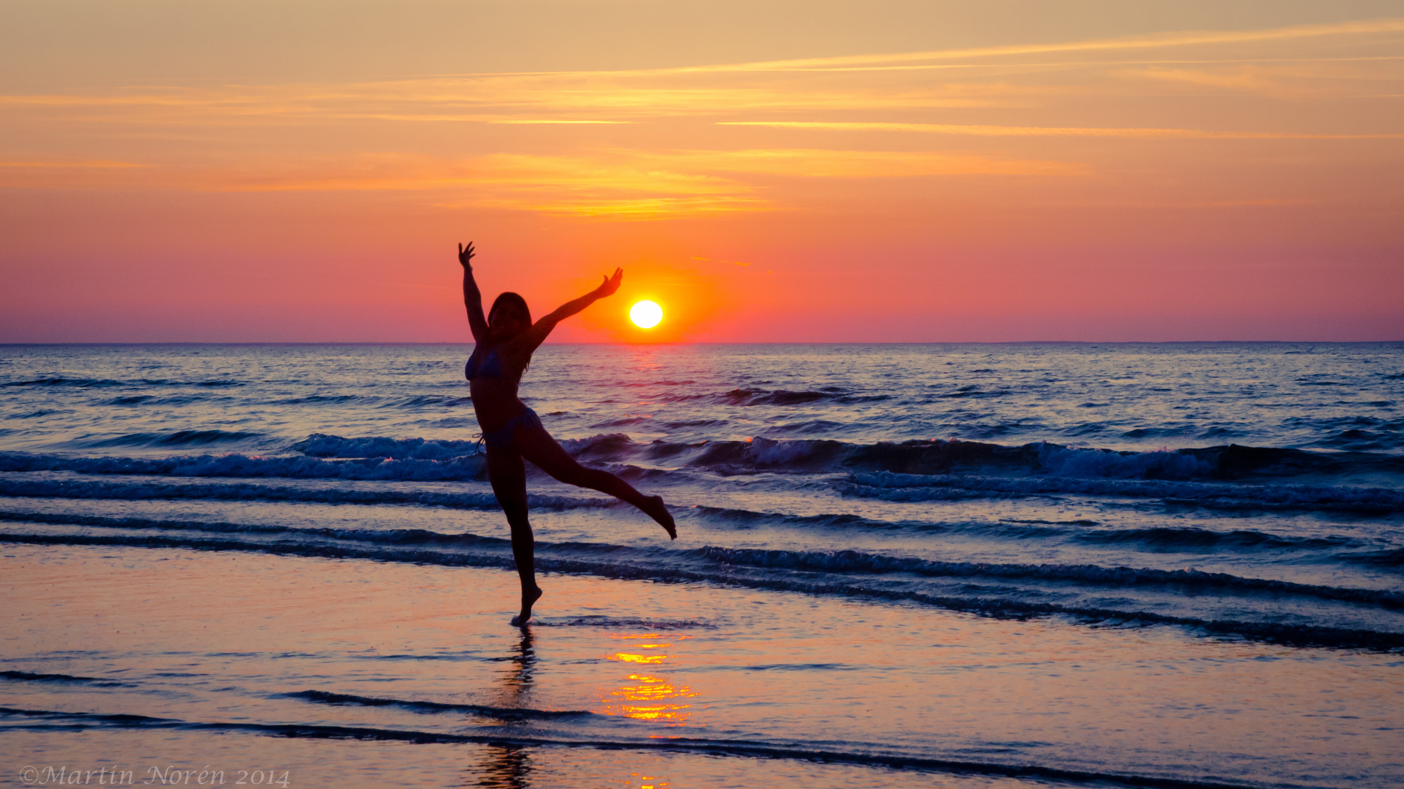 silhouette of woman dancing near seawave during sunset water 2k 4k 5k