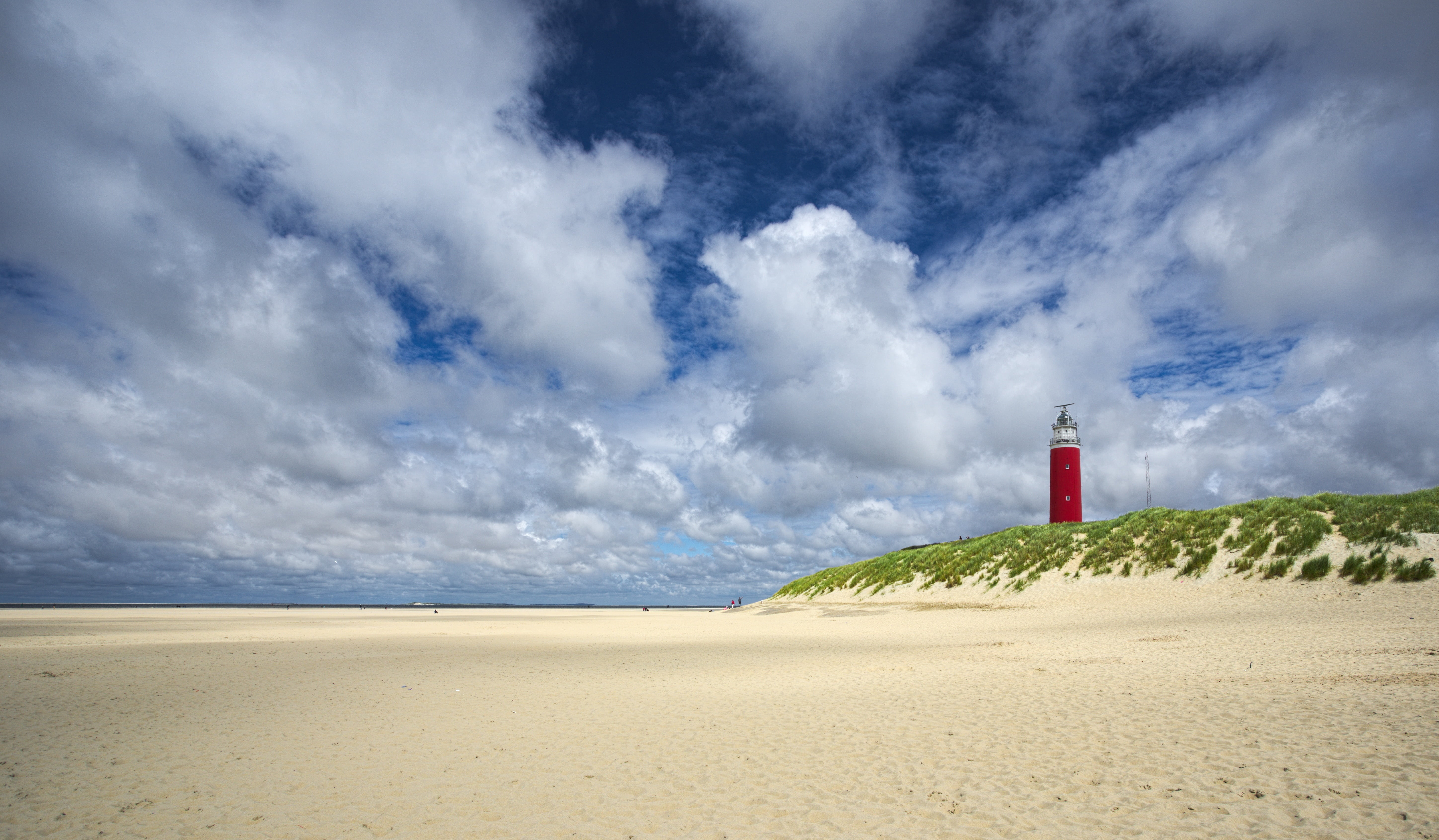 in distant photo of red lighthouse on landscape beach texel 2k 4k 5k