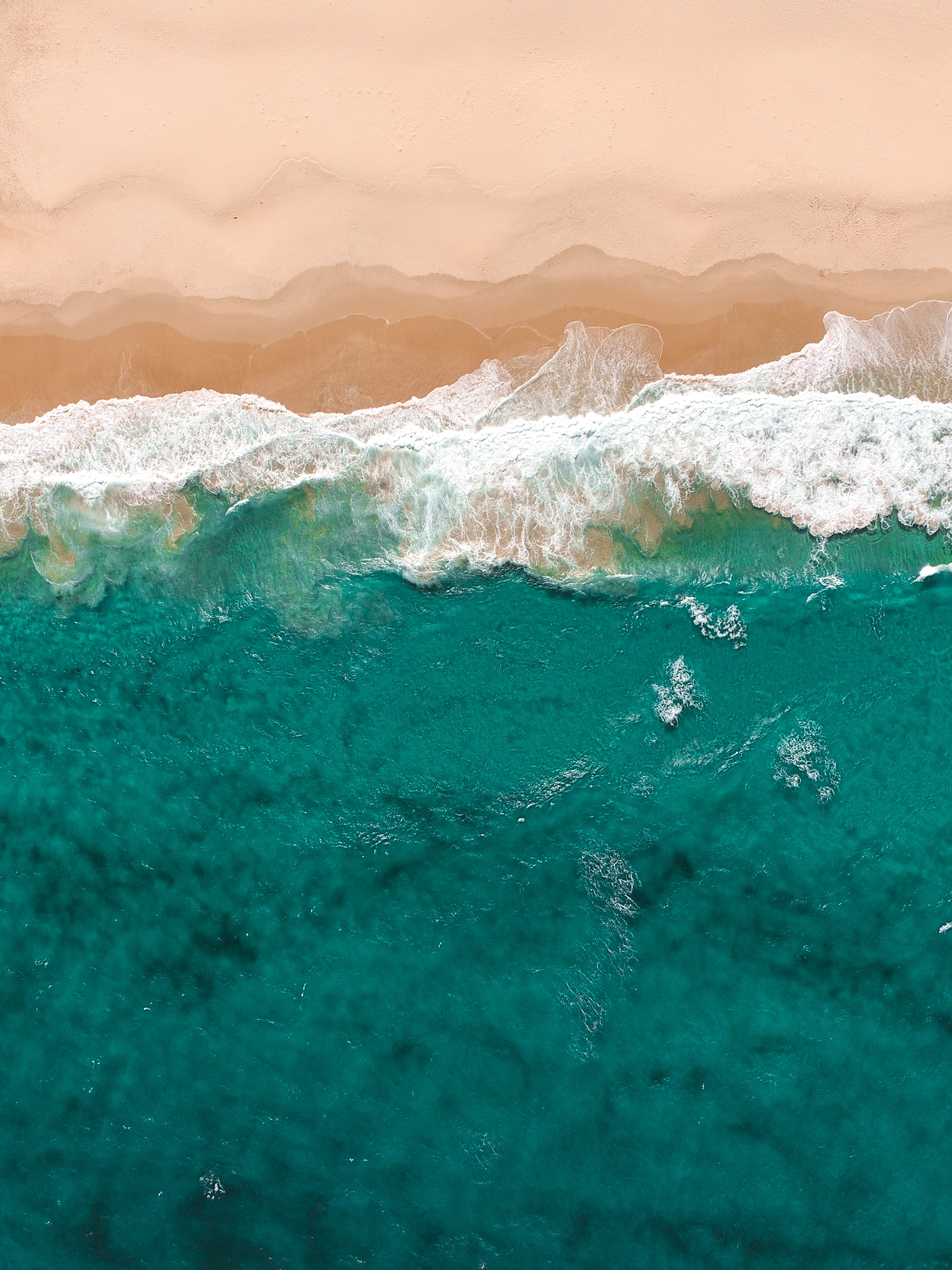 iPhone wallpaper aerial view of flowing sea water beside seashore 2k