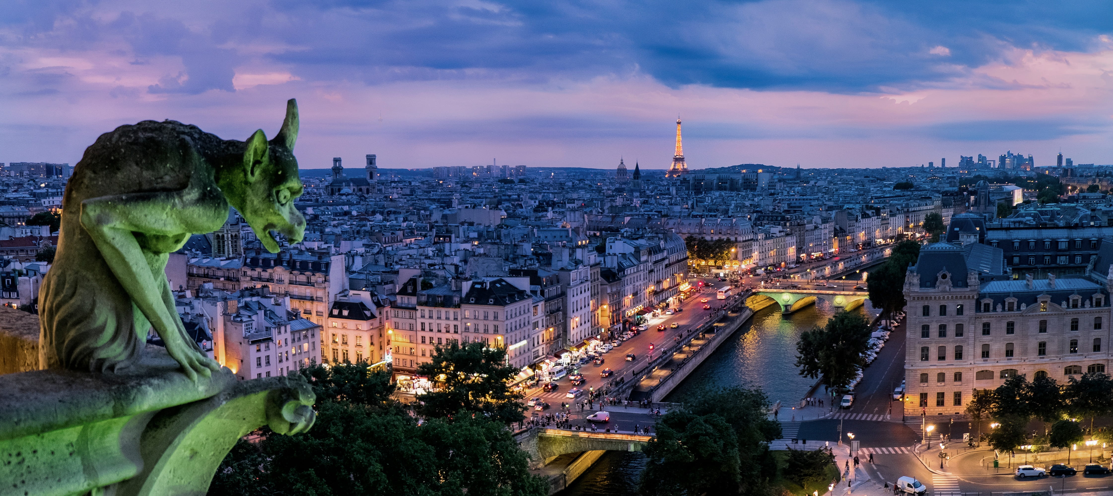 view stone gargoyle statue with city landscape in background during dusk 2k 4k