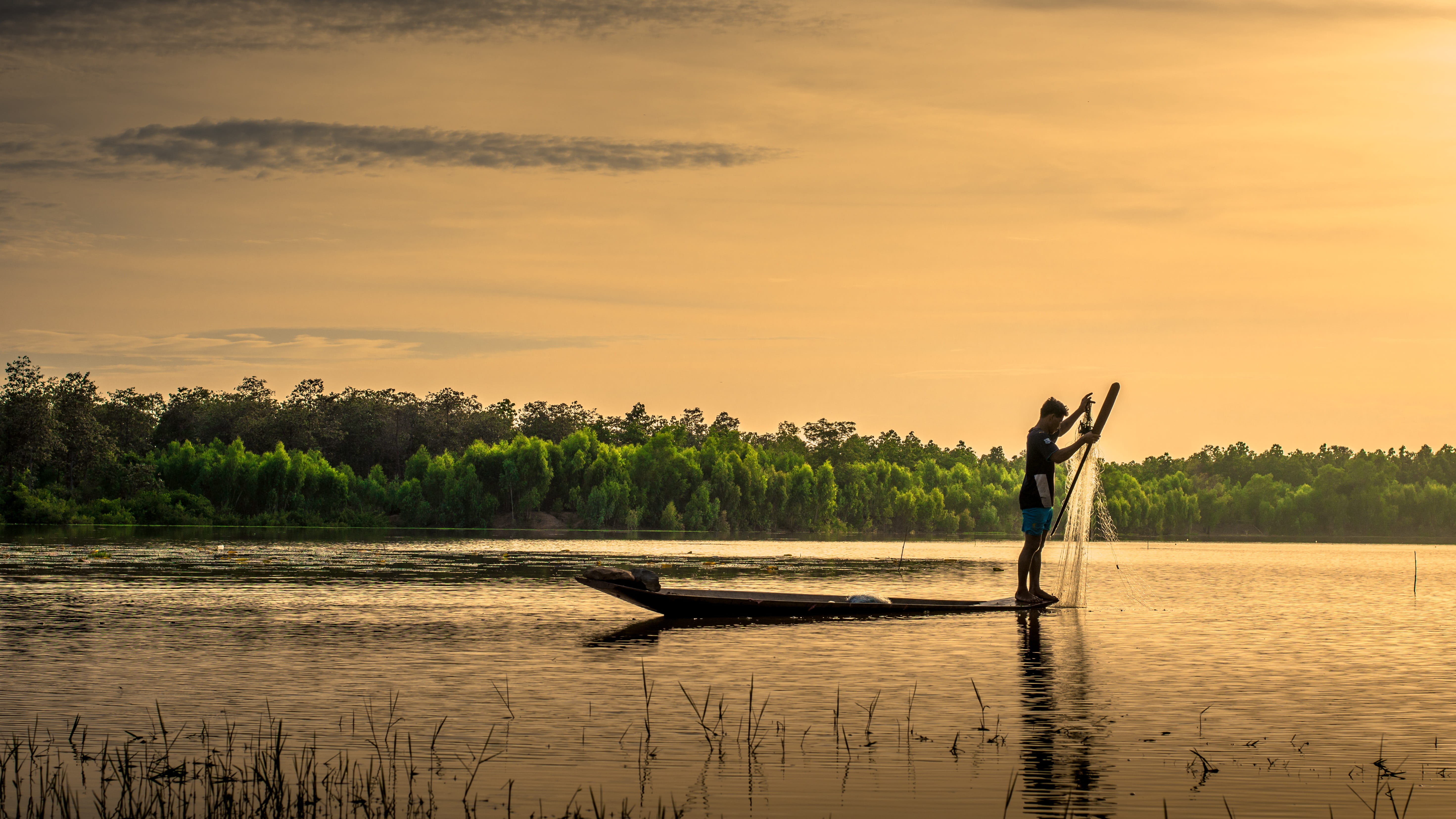 man on boat holding fish net Outside House Thailand Plant 2k 4k 5k