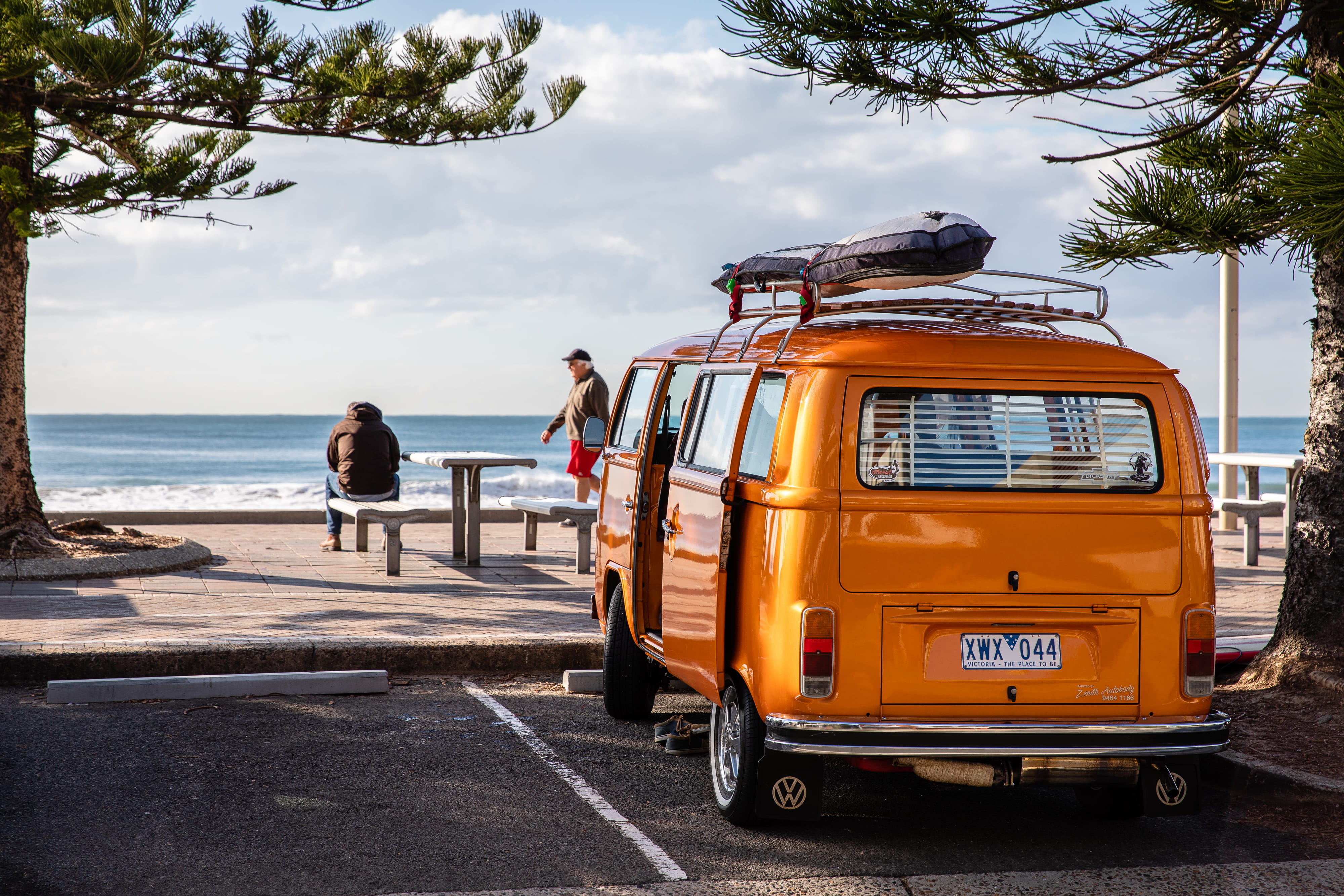 orange van park beside tree travel australia vintage vehicle 2k 4k