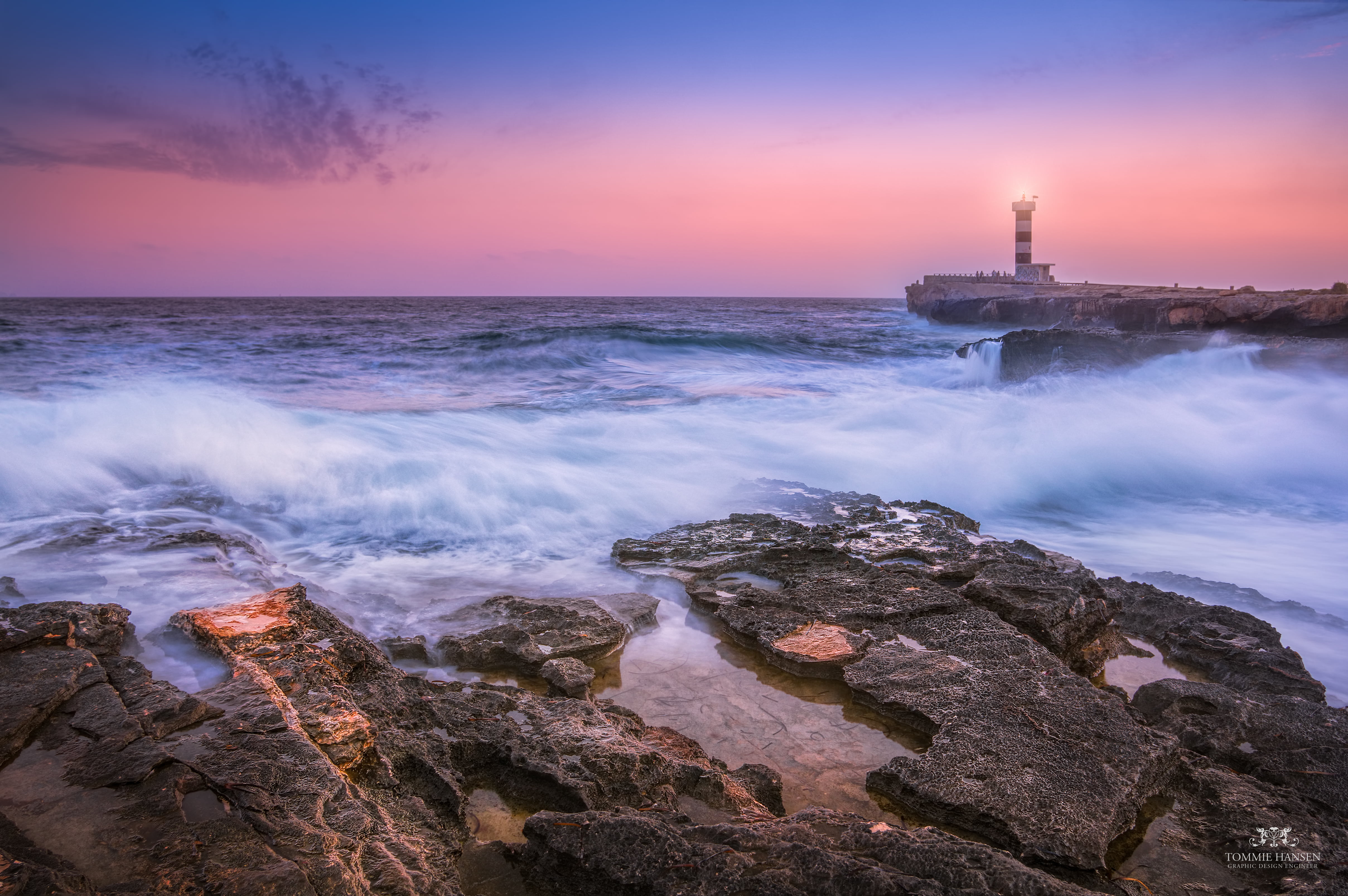 sea wave crashing on rock formation with light house view mallorca spain 2k 4k 5k