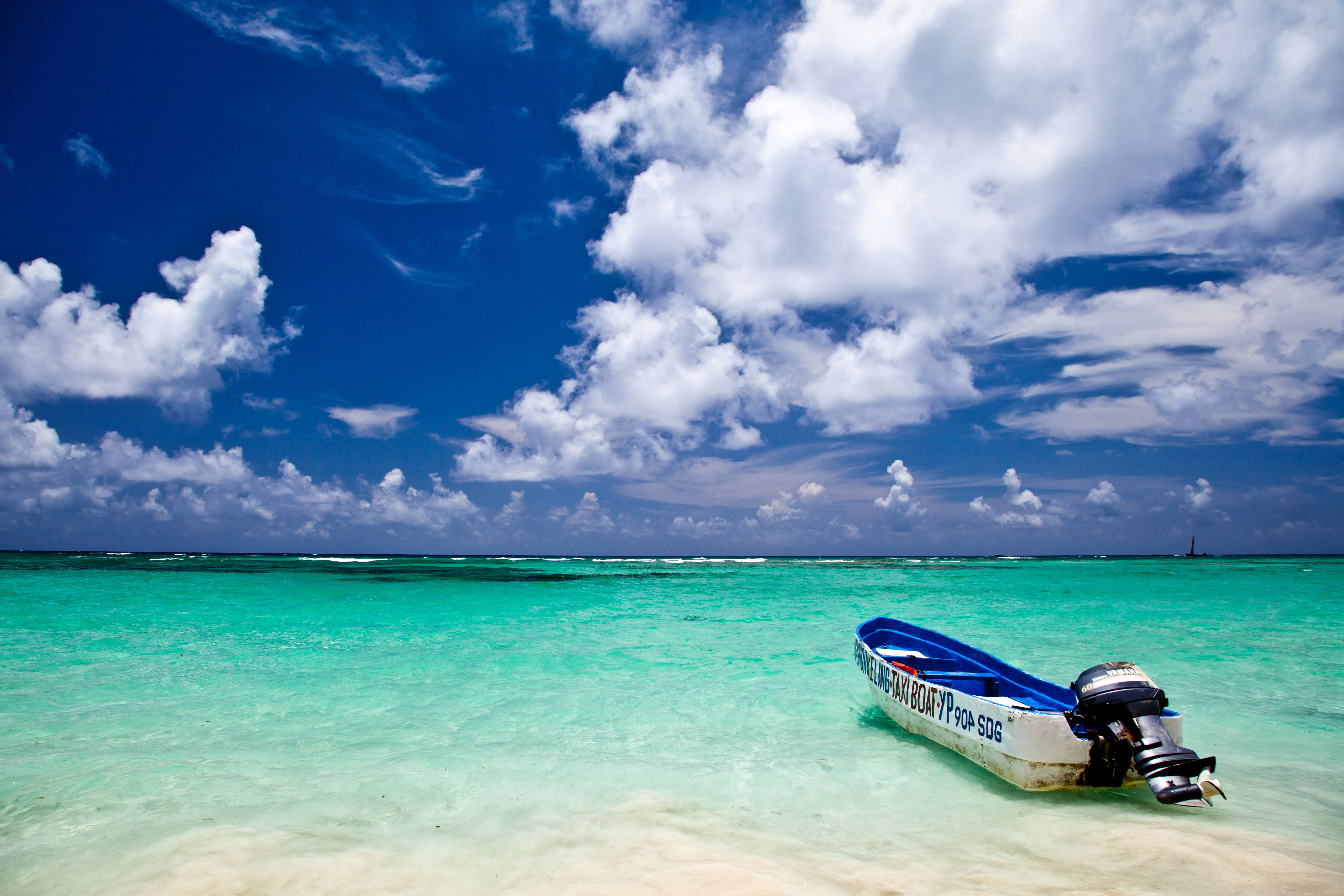 white and blue speedboat on ocean under sky during daytime punta cana dominican republic 2k 4k 5k