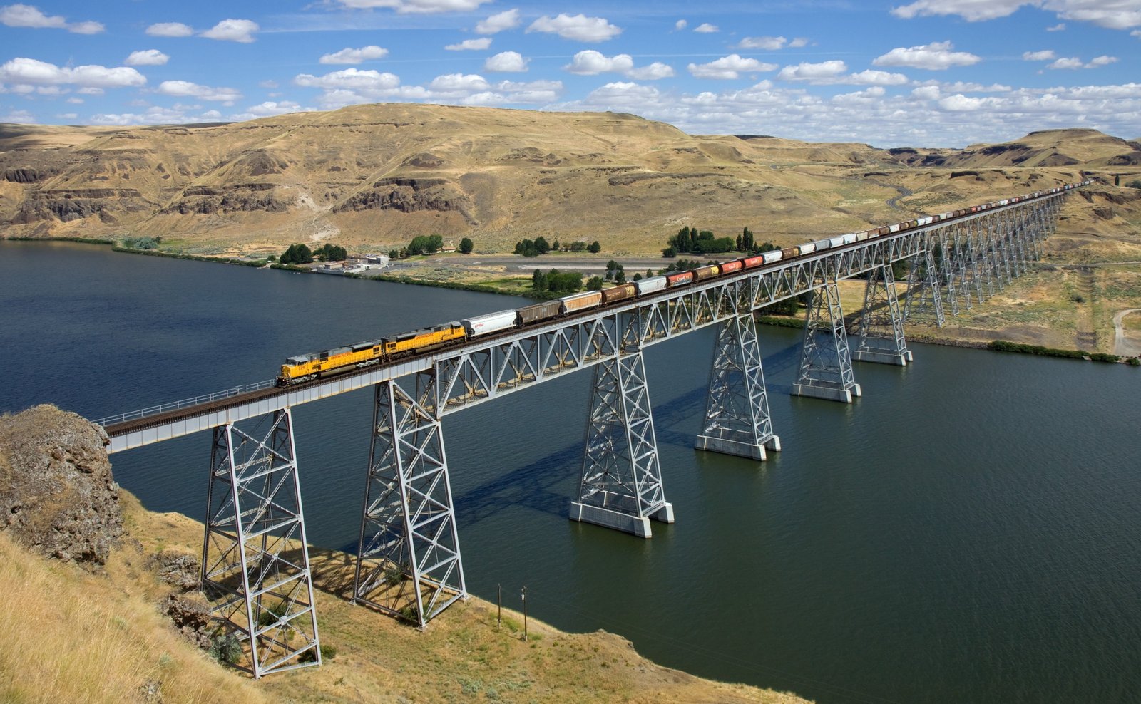 yellow white and black train nature landscape water bridge 2k 4k