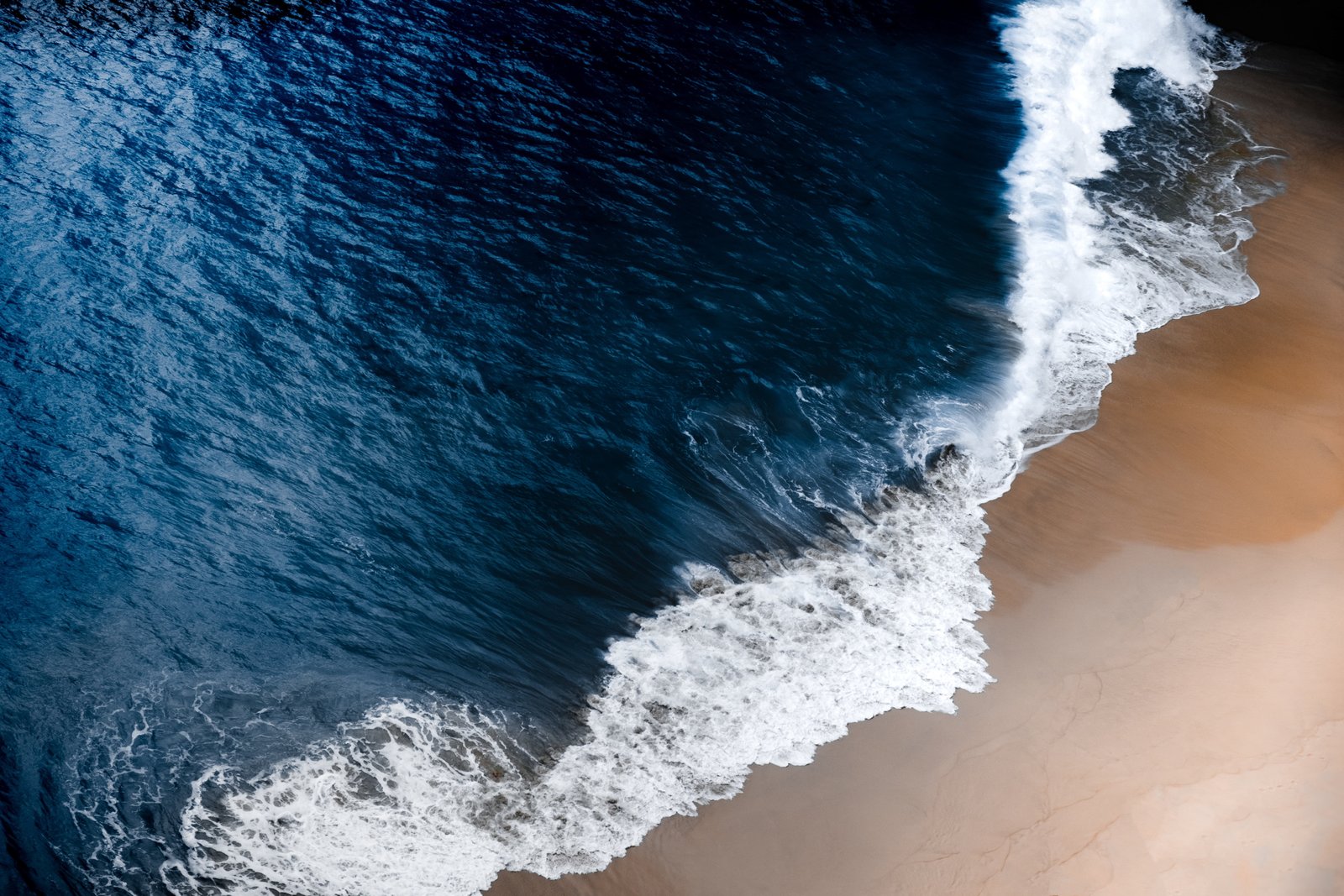 blue and brown beach aerial photography of ocean waves on seashore 2k 4k 5k