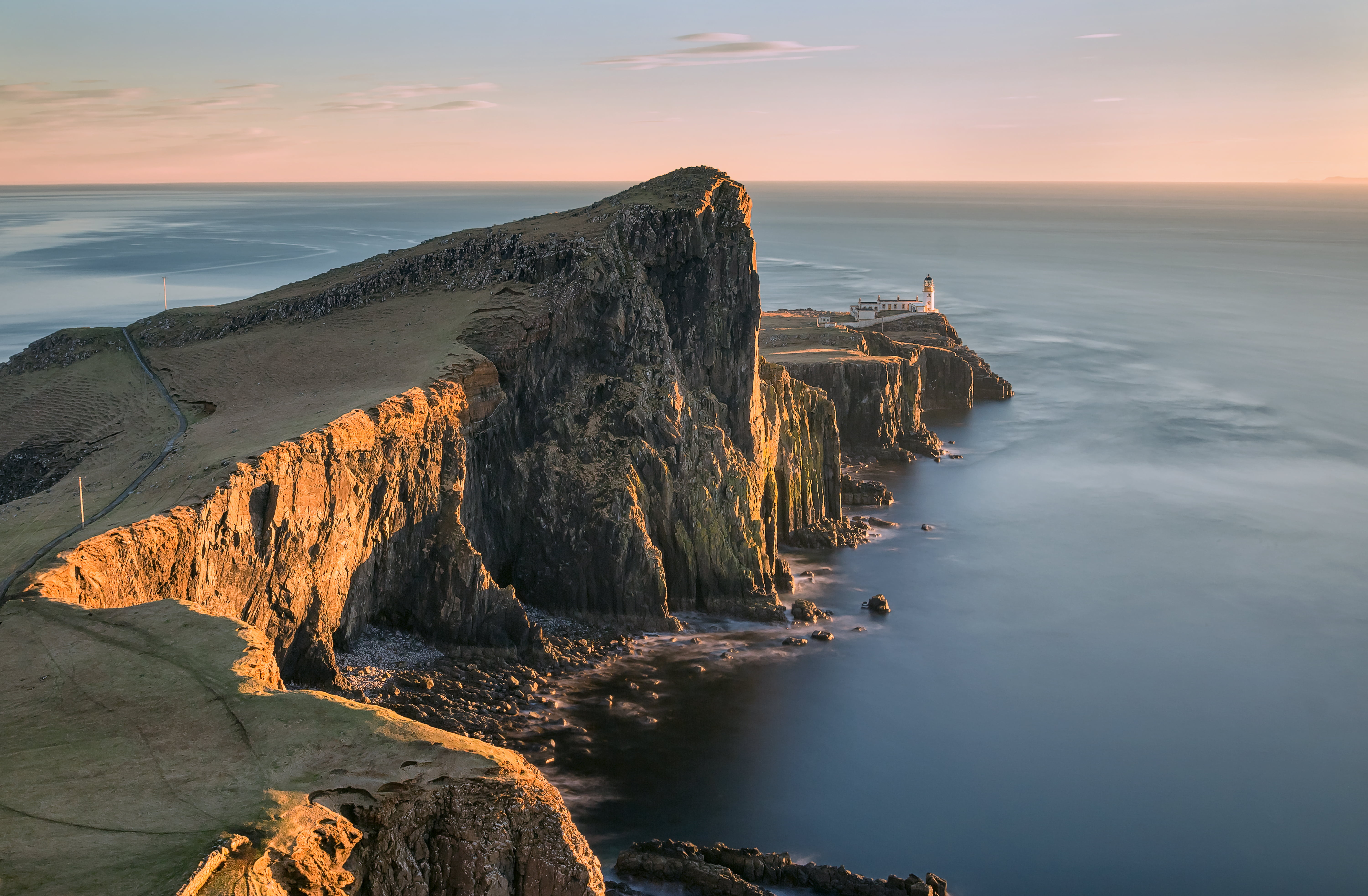 brown cliff over body of water under blue skies neist point skye 2k 4k 5k