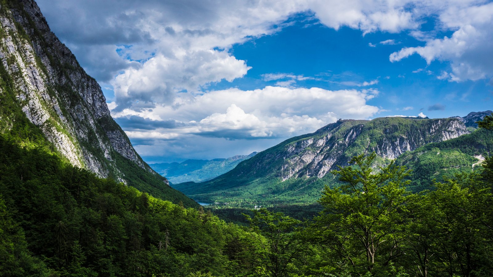 green mountains under white and blue cloudy sky during daytime 2k 4k 5k