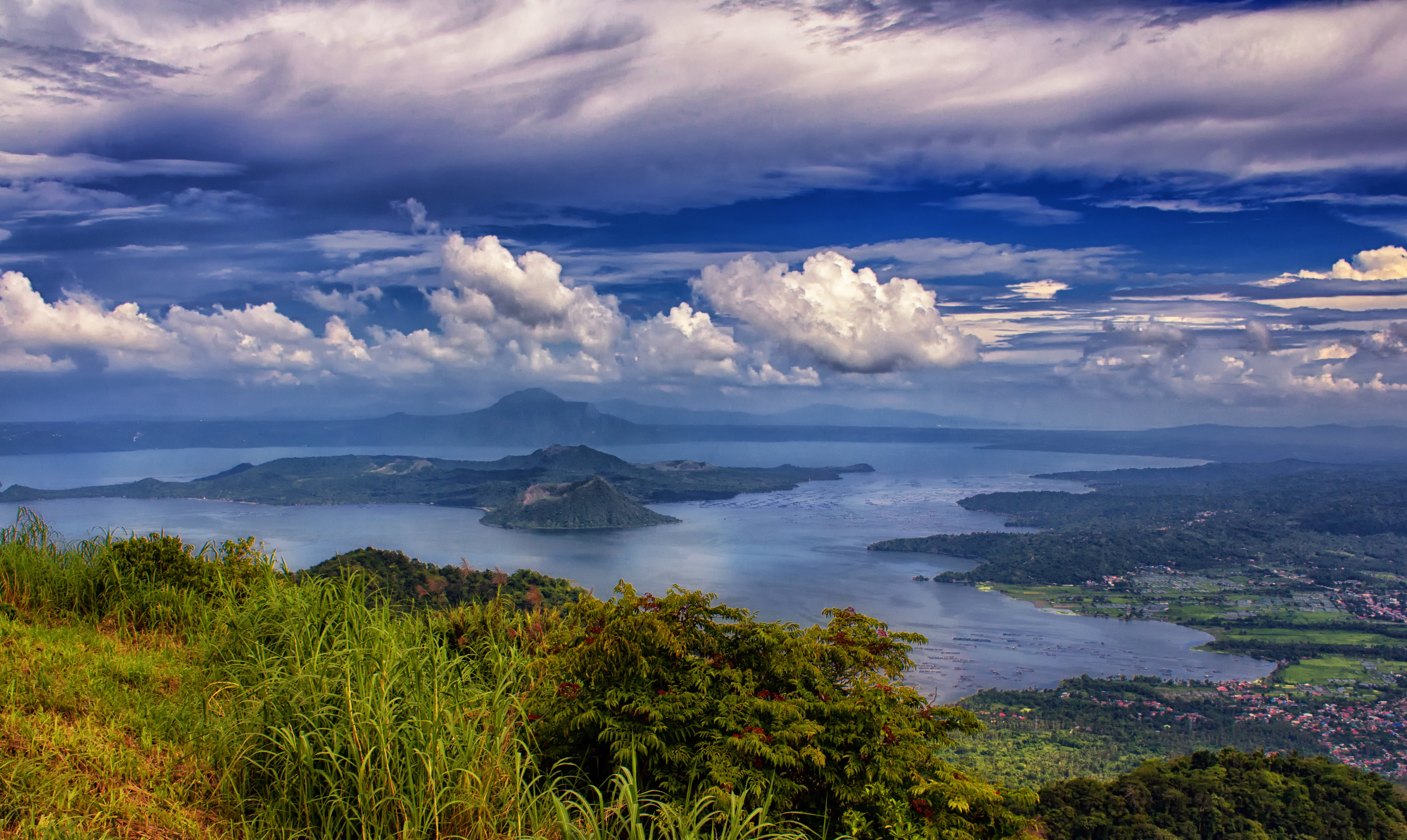 green trees surrounded by body of water under cloudy sky taal lake tagaytay philippines 2k 4k 5k