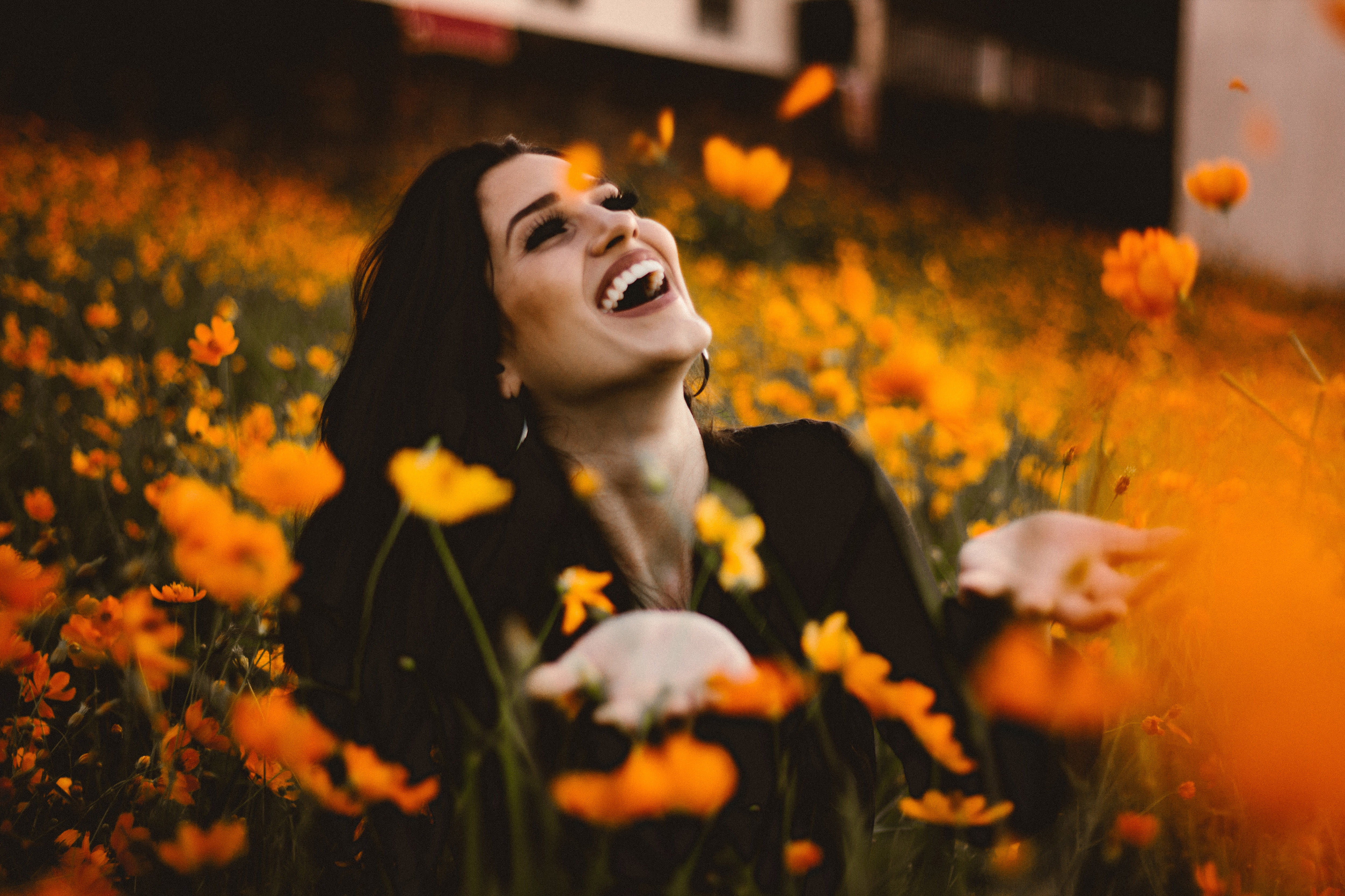 Laughing woman in flowers with smile people happy nature women 2k 4k 5k