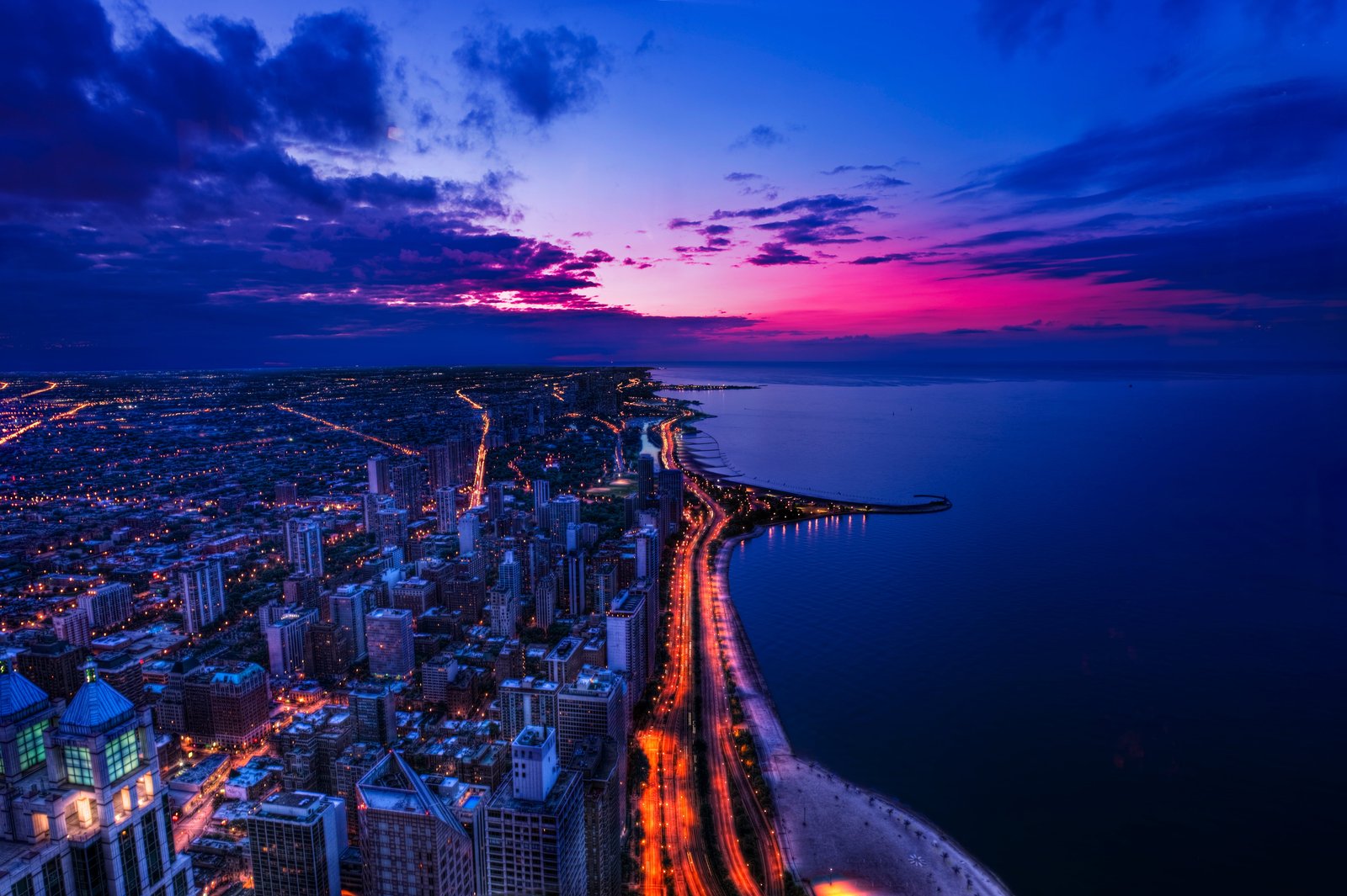 view of buildings beside ocean during night time The Great Snake 2k 4k 5k