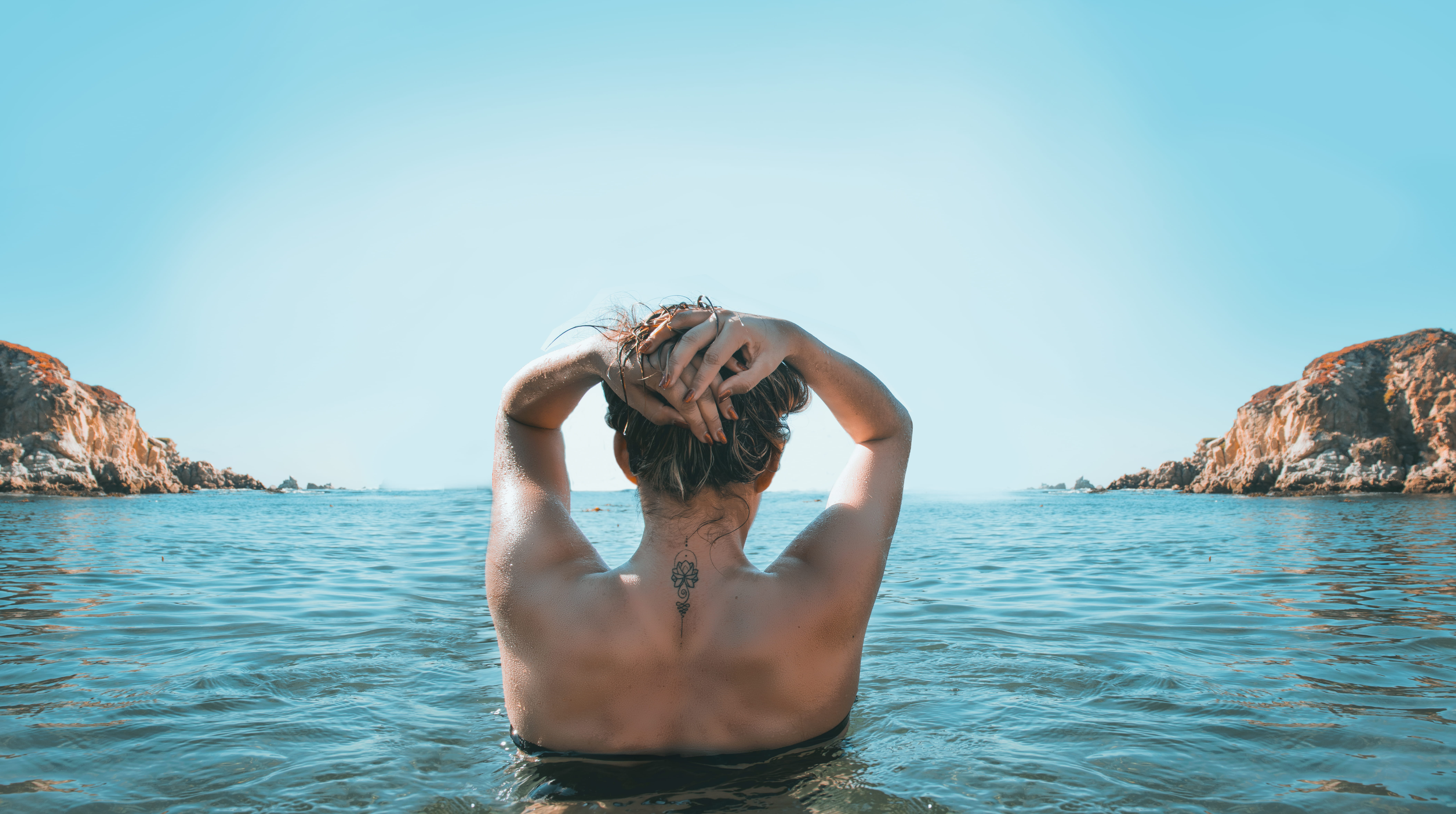 Woman on Holding Her Head While Standing Body of Water beach 2k 4k 5k 8k
