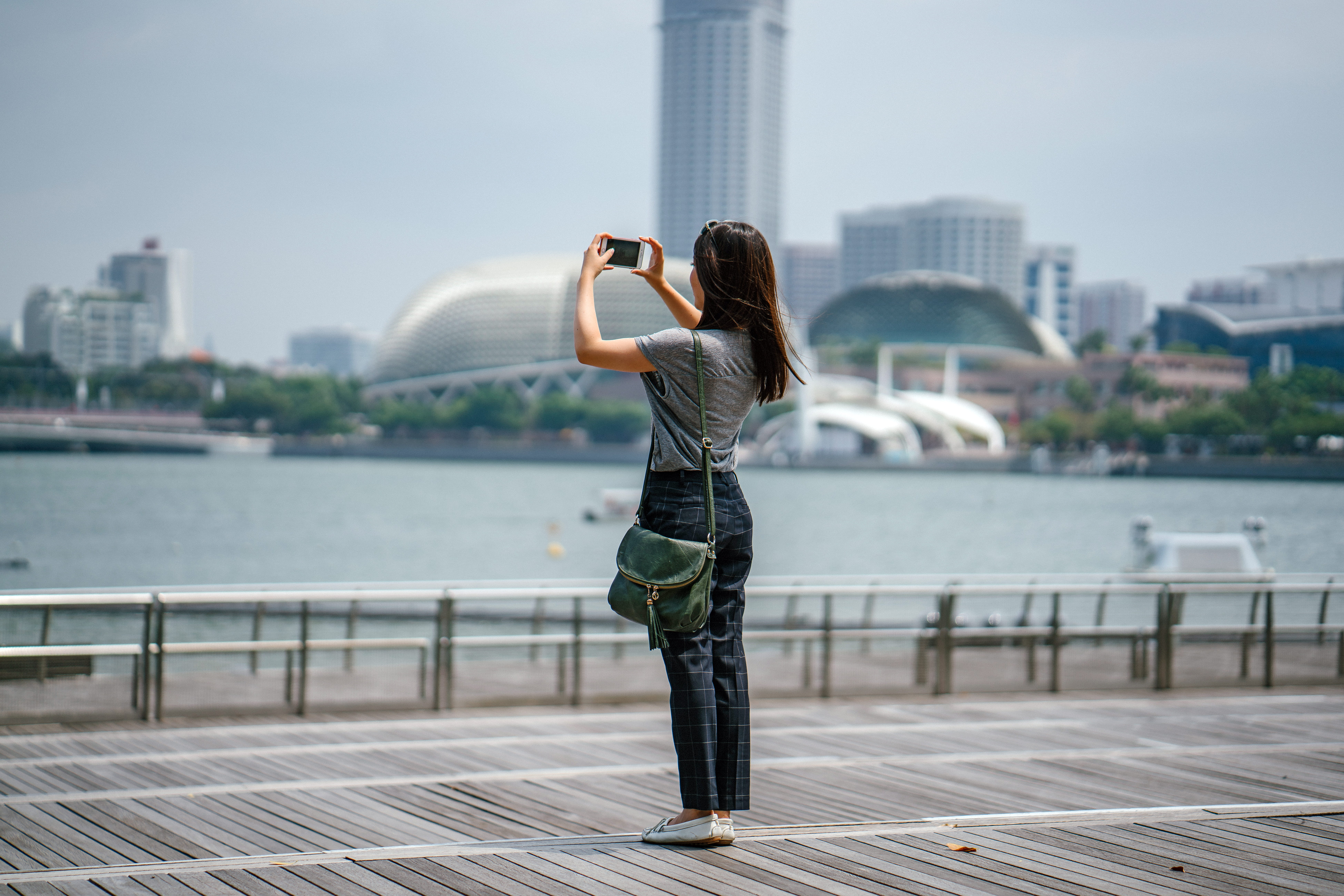 Woman Standing Taking Picture of Scenery architecture bay blurred background 2k 4k 5k 8k