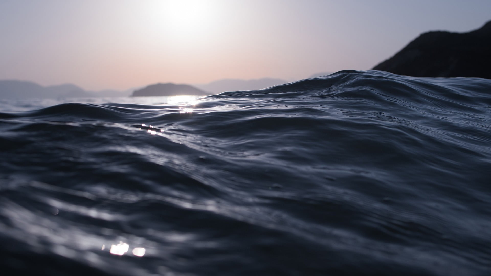 body of water closeup photo waves sunlight 2k