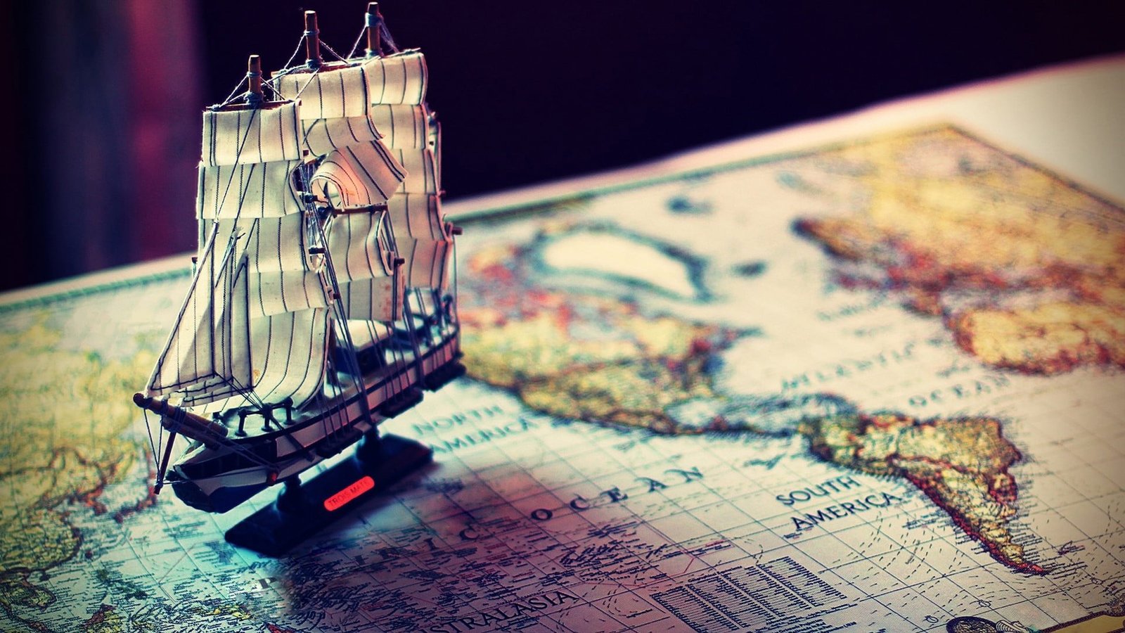 brown and white ship miniature sail on map world 2k