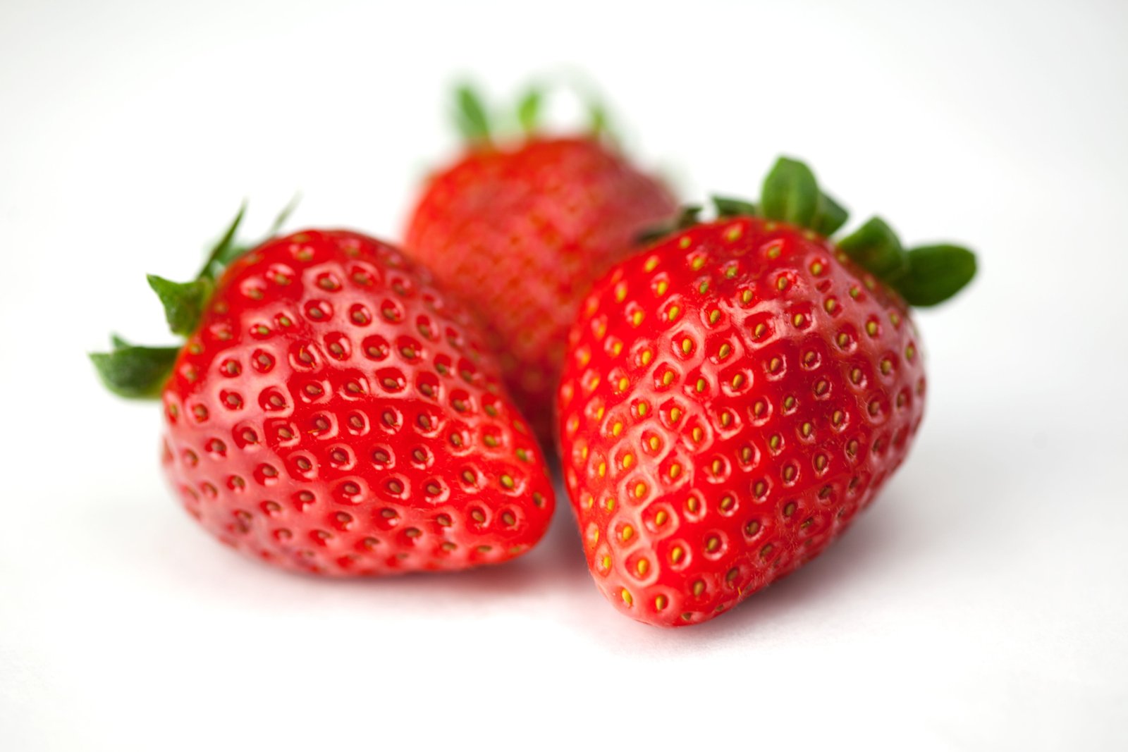 Close up macro shot of fresh strawberries on a white background image captured with Canon 2k 4k 5k