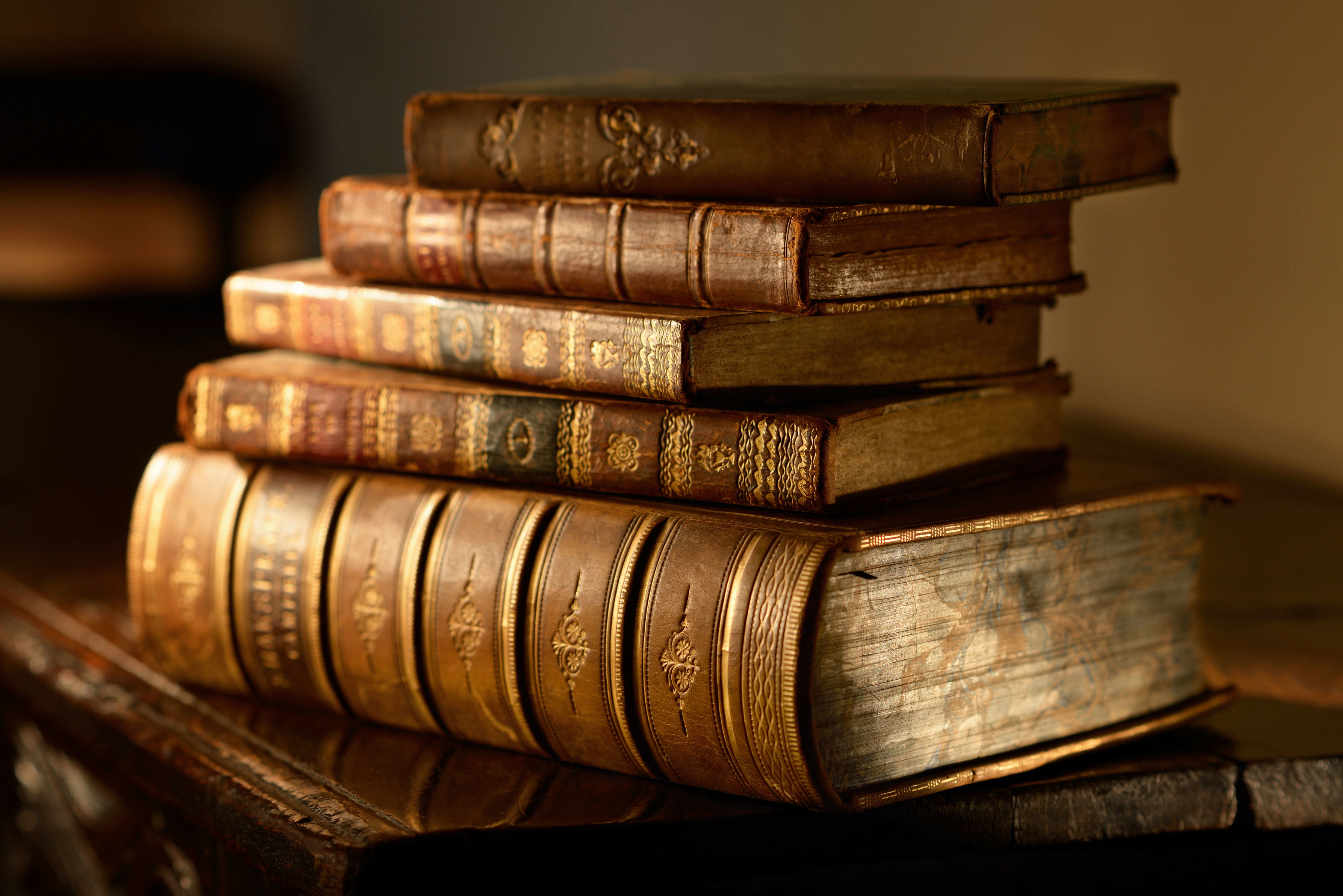 pile of brown books macro table blur stack vintage bokeh 2k 4k 5k