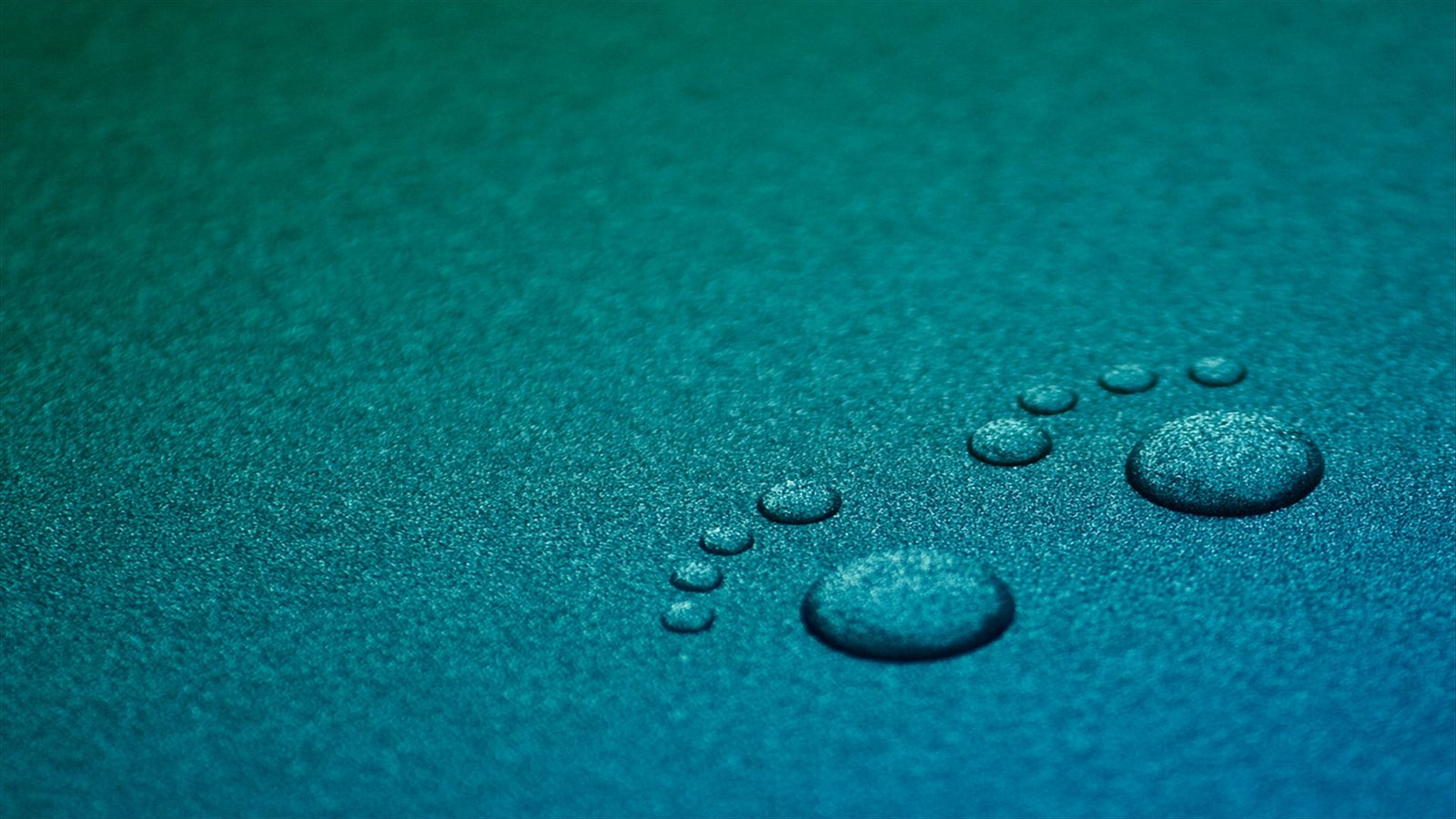 water droplets forming footprints drops GNOME close up 2k