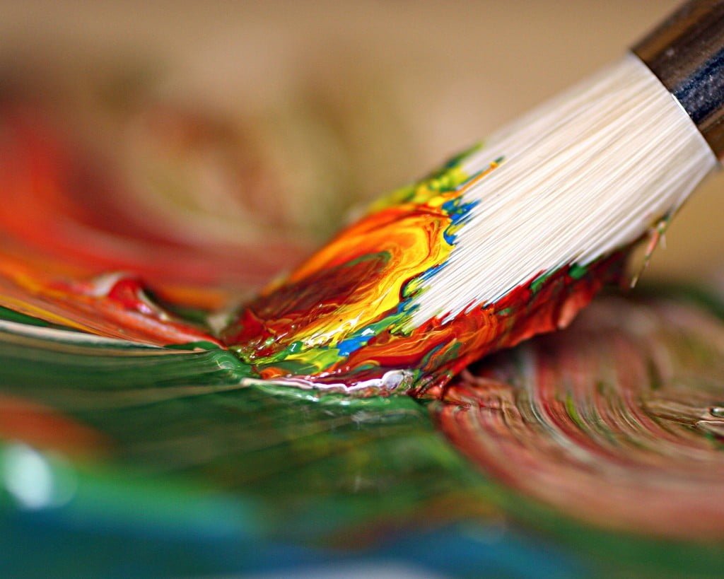 white paint brush close up photography of paintbrush dipped on multicolored