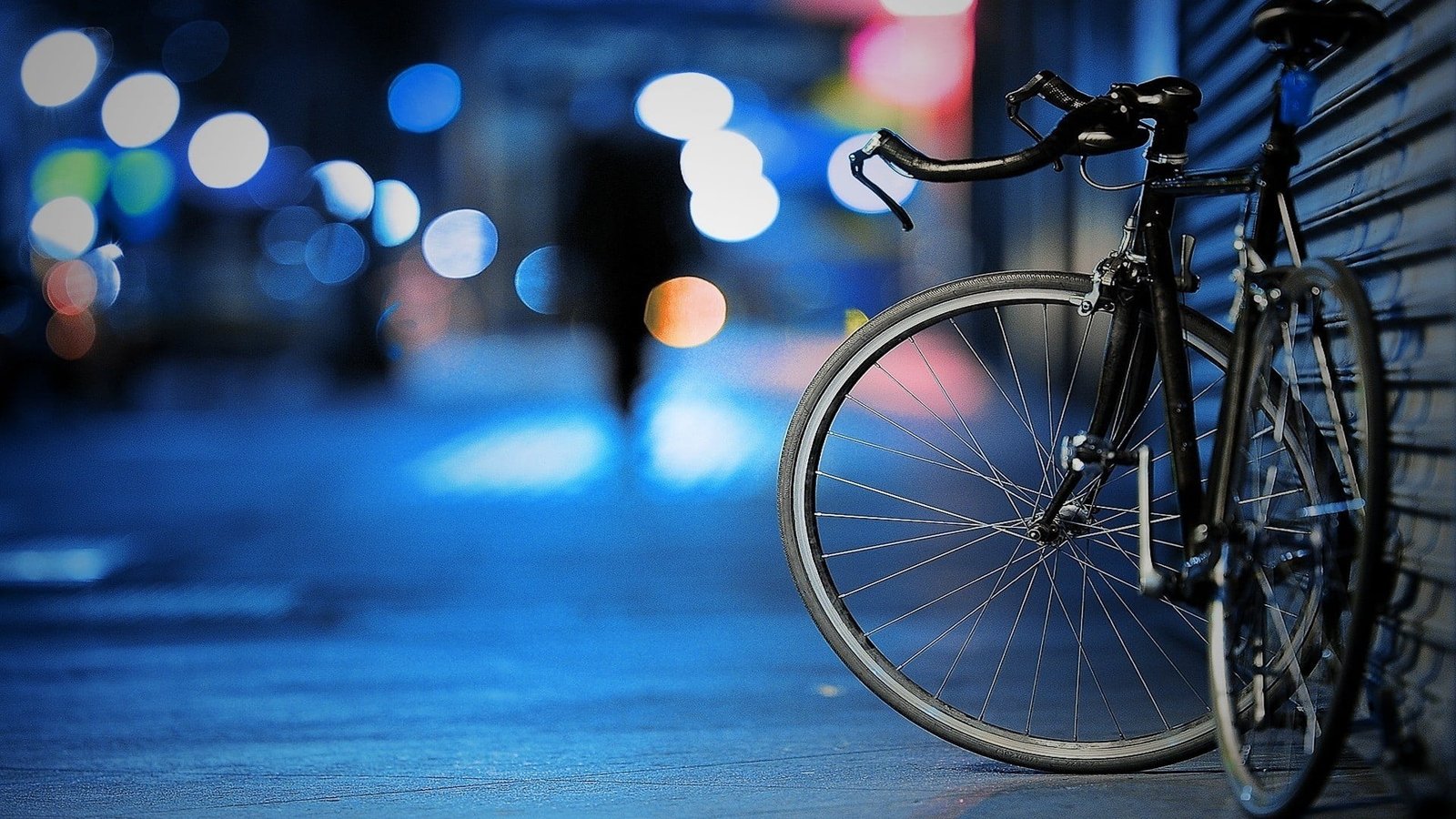 black road bike mountain beside wall depth of field 2k