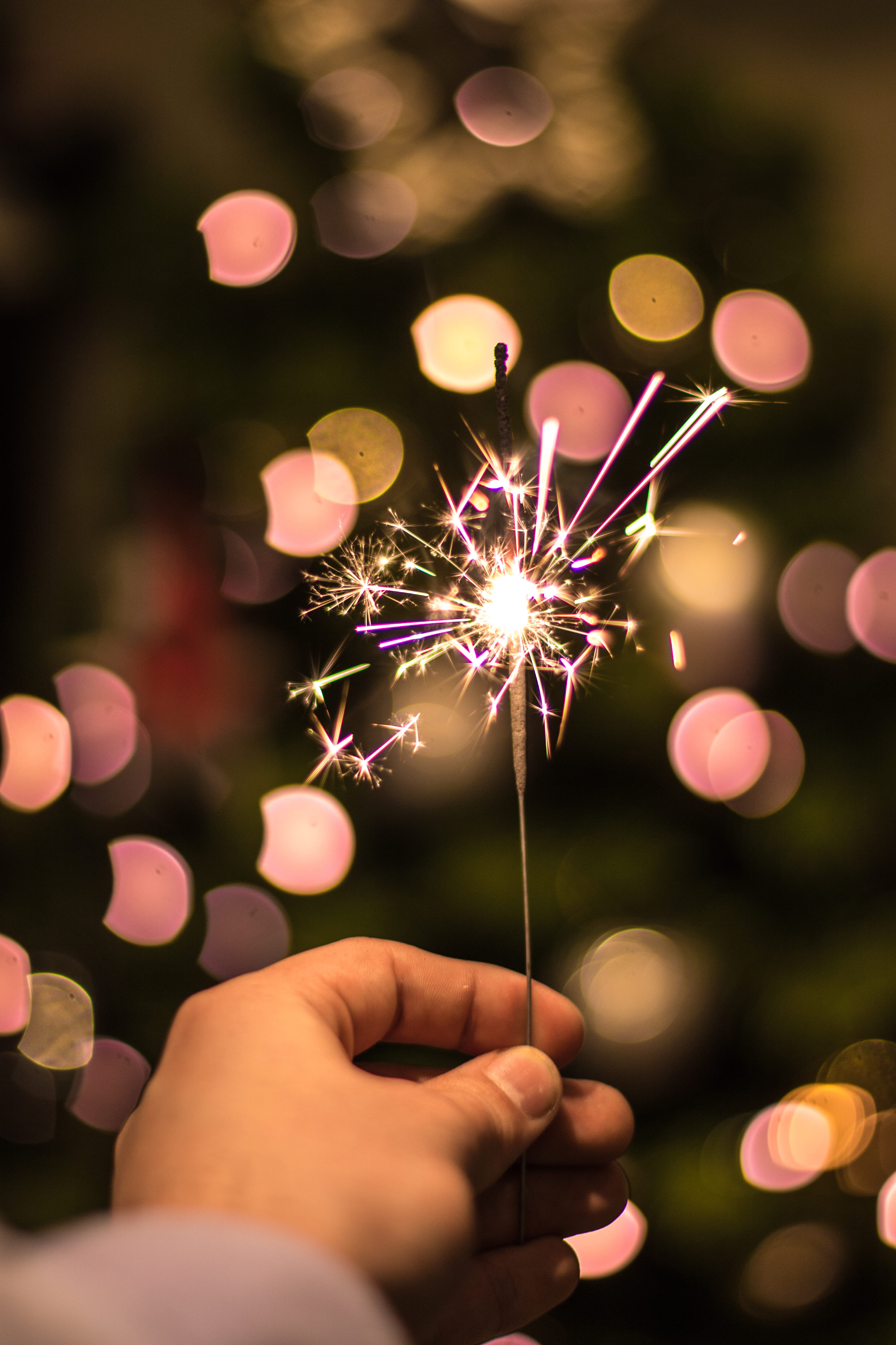 bokeh photography of person holding fireworks fire cracker 2k 4k