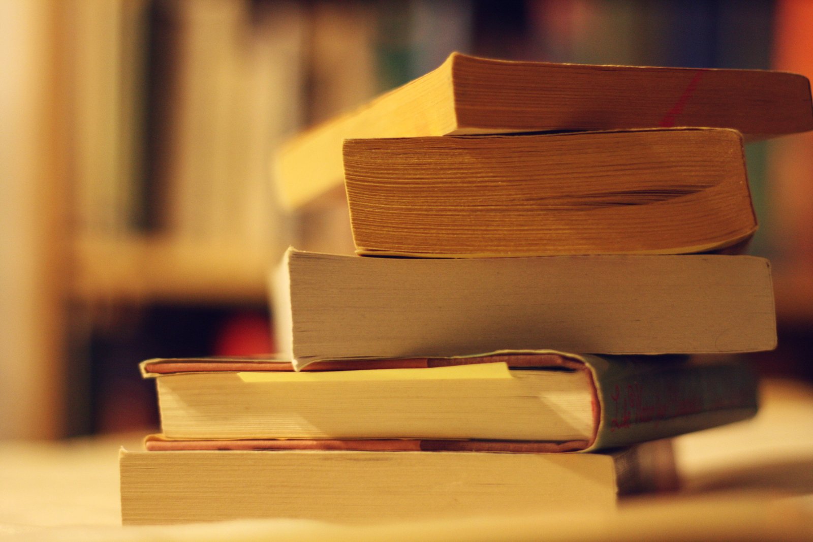 selective focus photo of layered books book sale loot stack 2k 4k