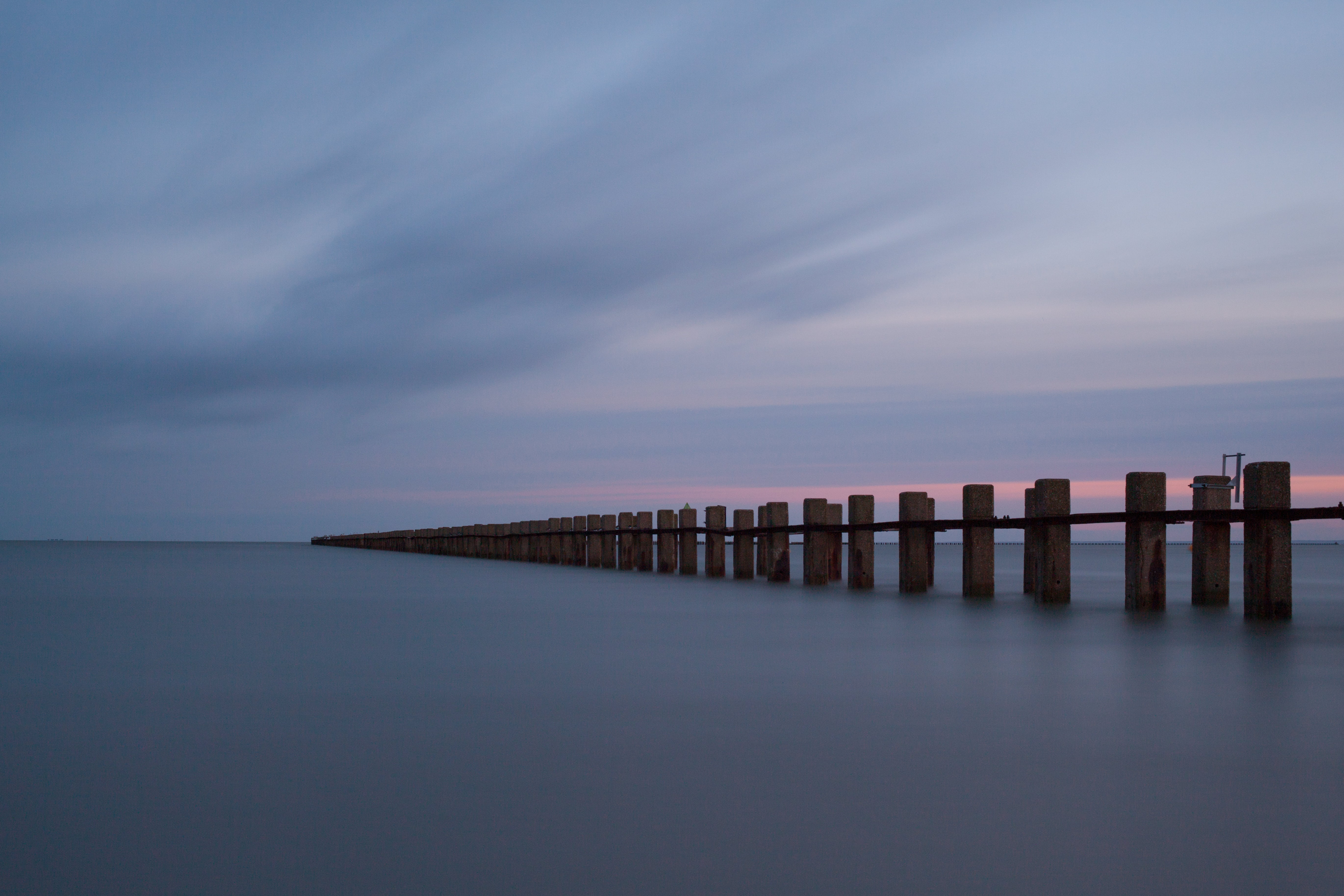 brown wooden posts on sea Out to Sea East Beach long exposure 2k 4k 5k