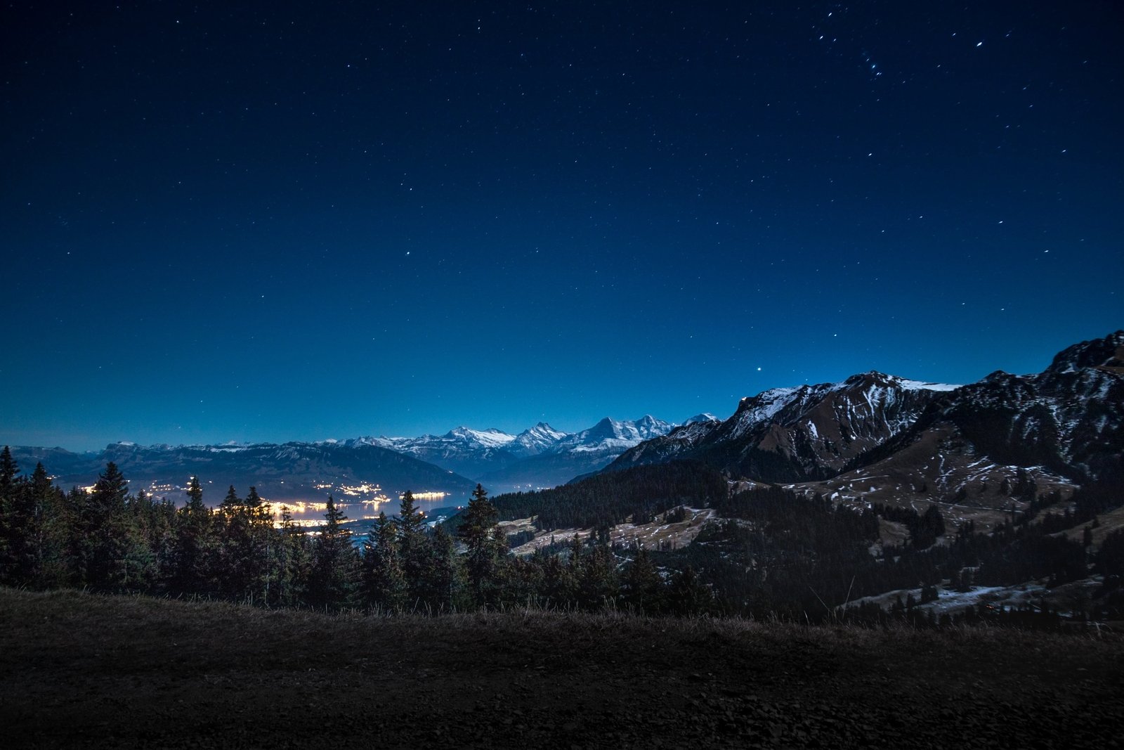 mountain range under blue sky night mountains city snow landscape 72 2k 4k 5k