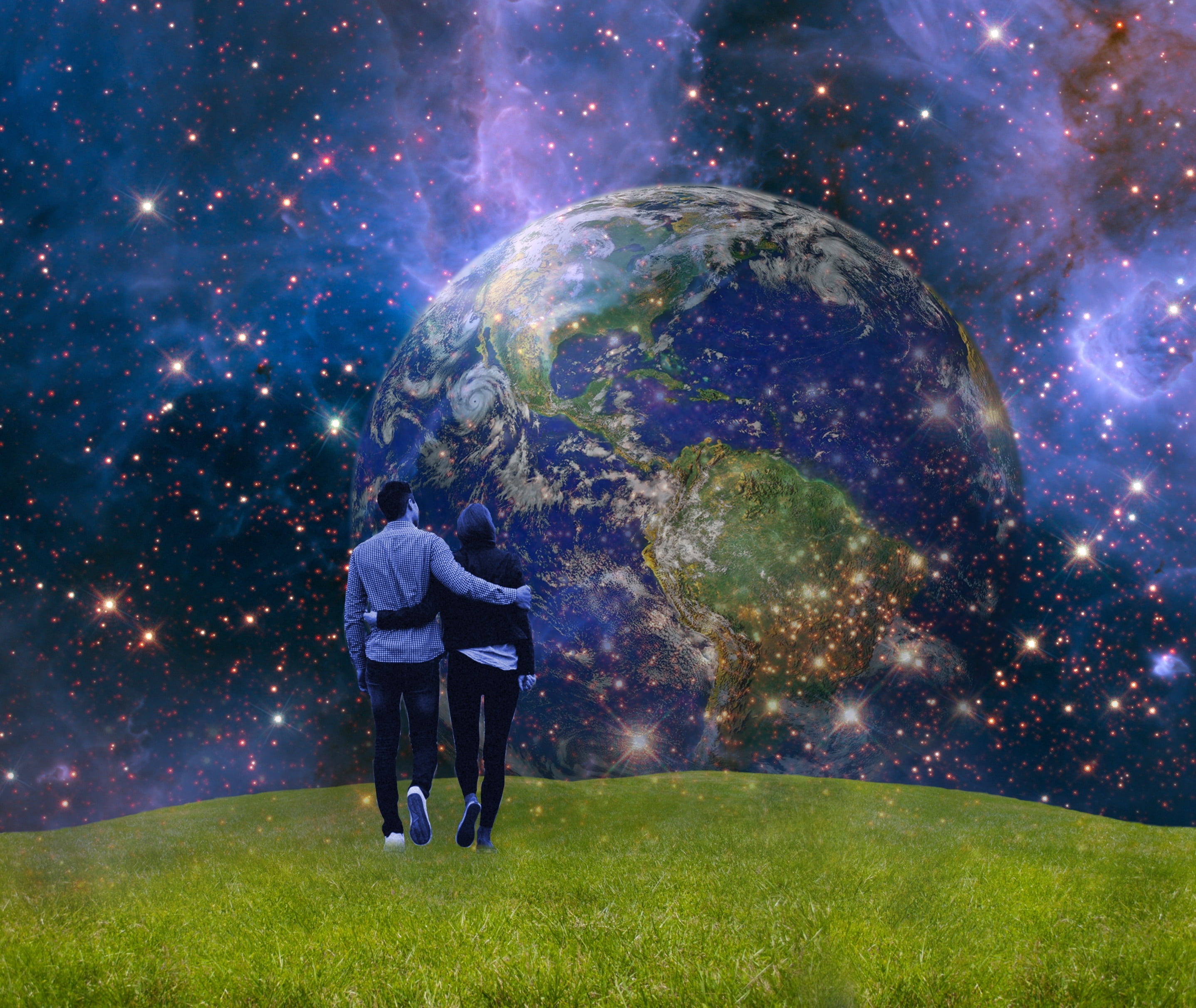 person standing on green field with universe wallpaper earth 2k