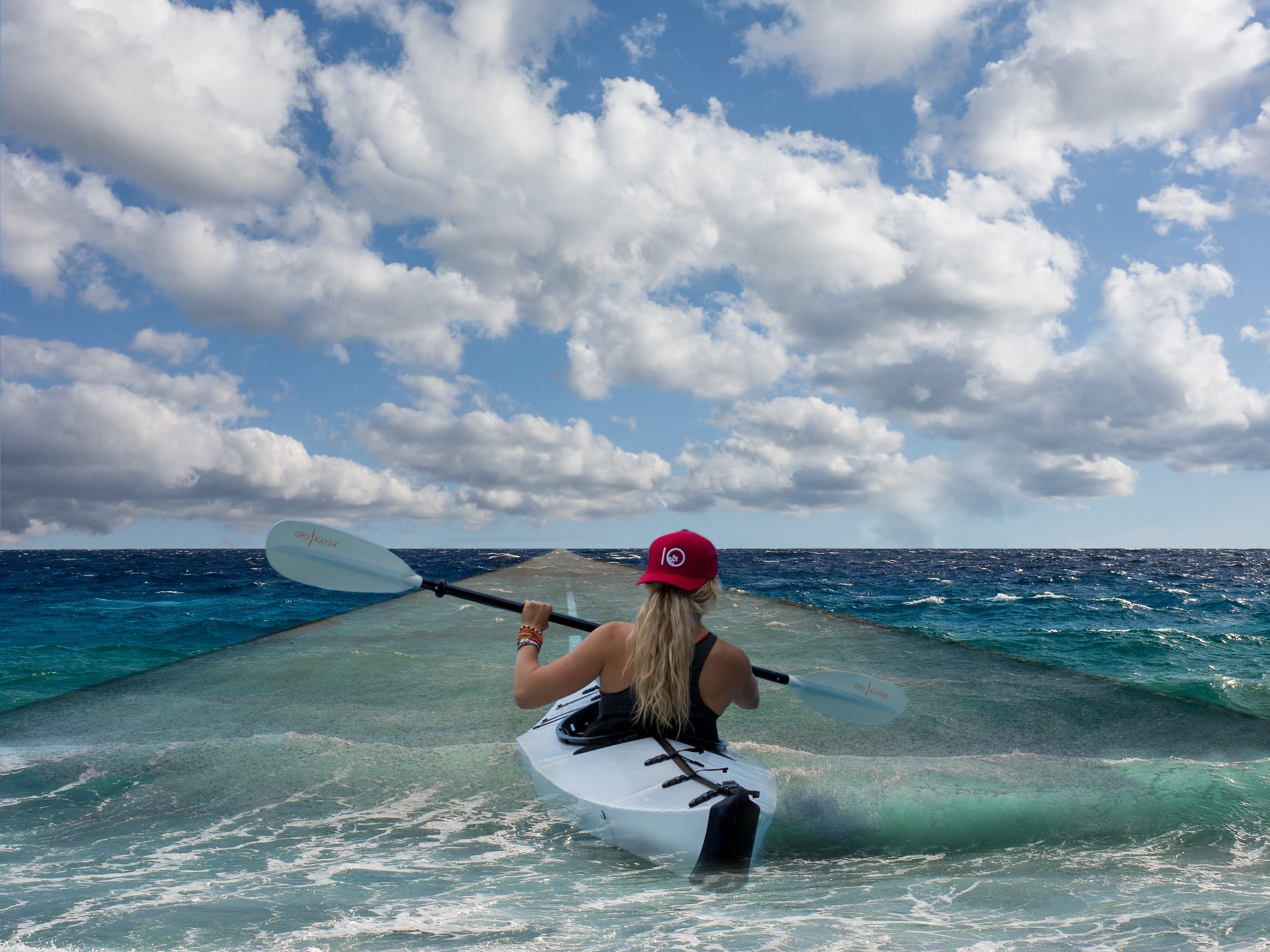 woman wearing black racerback tank top on white kayak under clouds 2k 4k