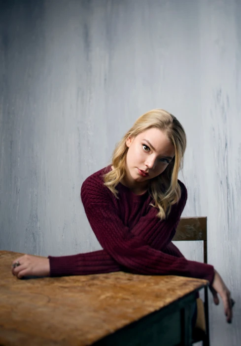 Anya Taylor Joy women actress blonde sitting simple background