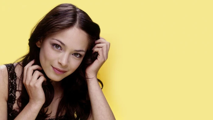 Kristin Kreuk actress yellow background smiling portrait