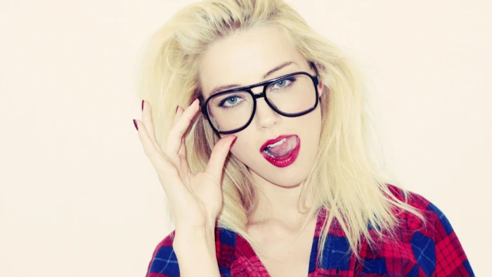 woman wearing black framed eyeglasses and red lipstick blonde