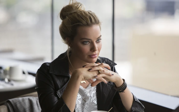 women's black leather jacket Margot Robbie painted nails blue eyes