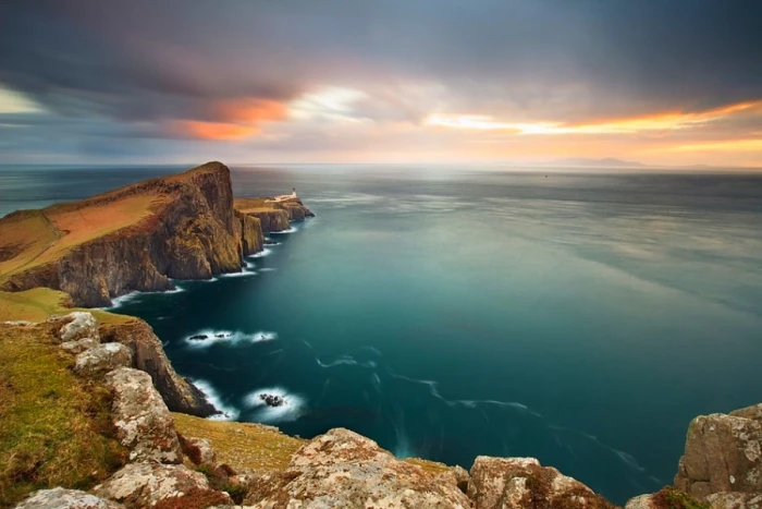 aerial photography of cliff overlooking sea during golden hour