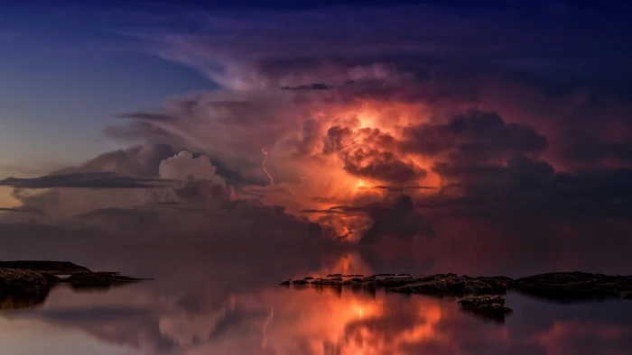 lightning illustration rock formation on body of water sky 2k