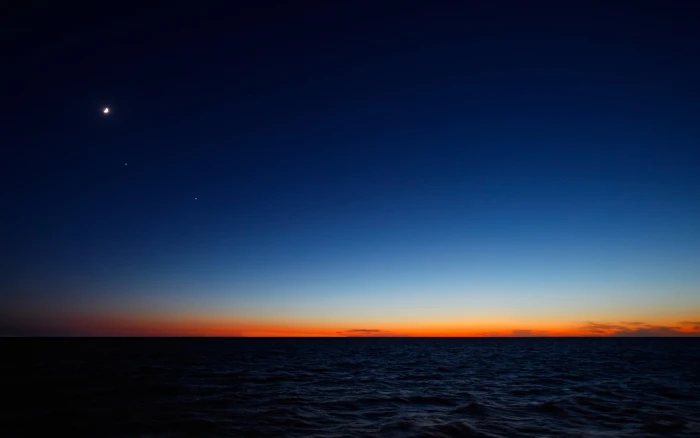 body of water during sunset sky sea nature horizon over 2k