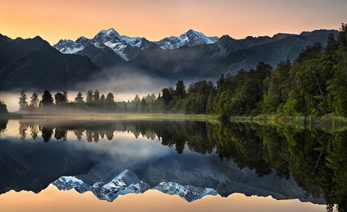 body of water beside trees nature landscape lake reflection