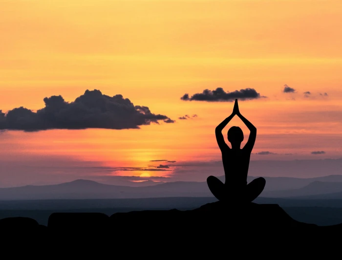 silhouette of person taking yoga pose meditation zen chan 2k