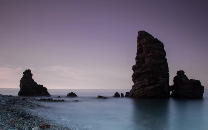 black rock formation beach water nature sea sky scenics 2k
