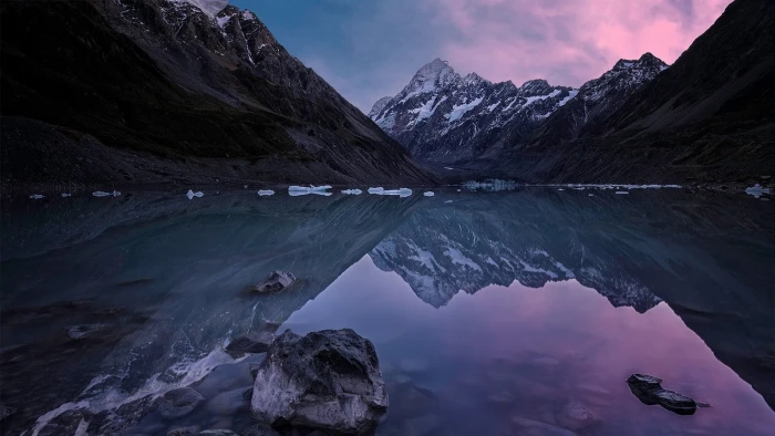 body of water beside mountain with snow nature landscape lake 2k