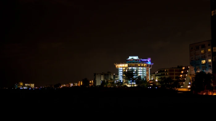 buildings lighted up at night lights beach illuminated architecture 2k