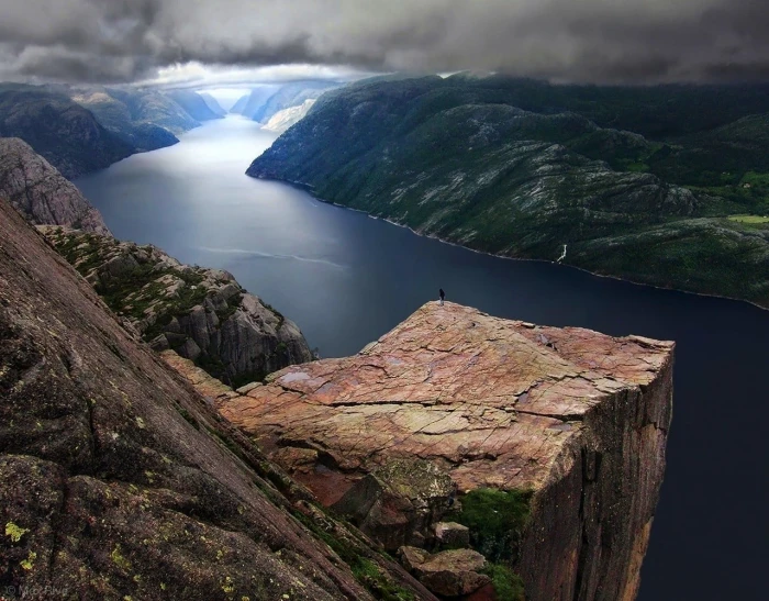 brown and black wooden table Preikestolen Norway fjord clouds