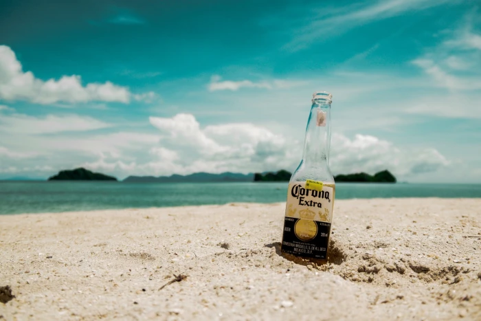 Corona Extra beer bottle on beach shore focus photography near 2k