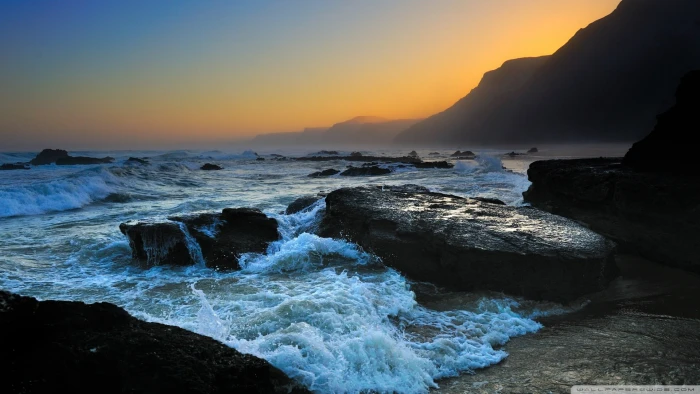beach coast sea sunset rocks water beauty in nature sky 2k